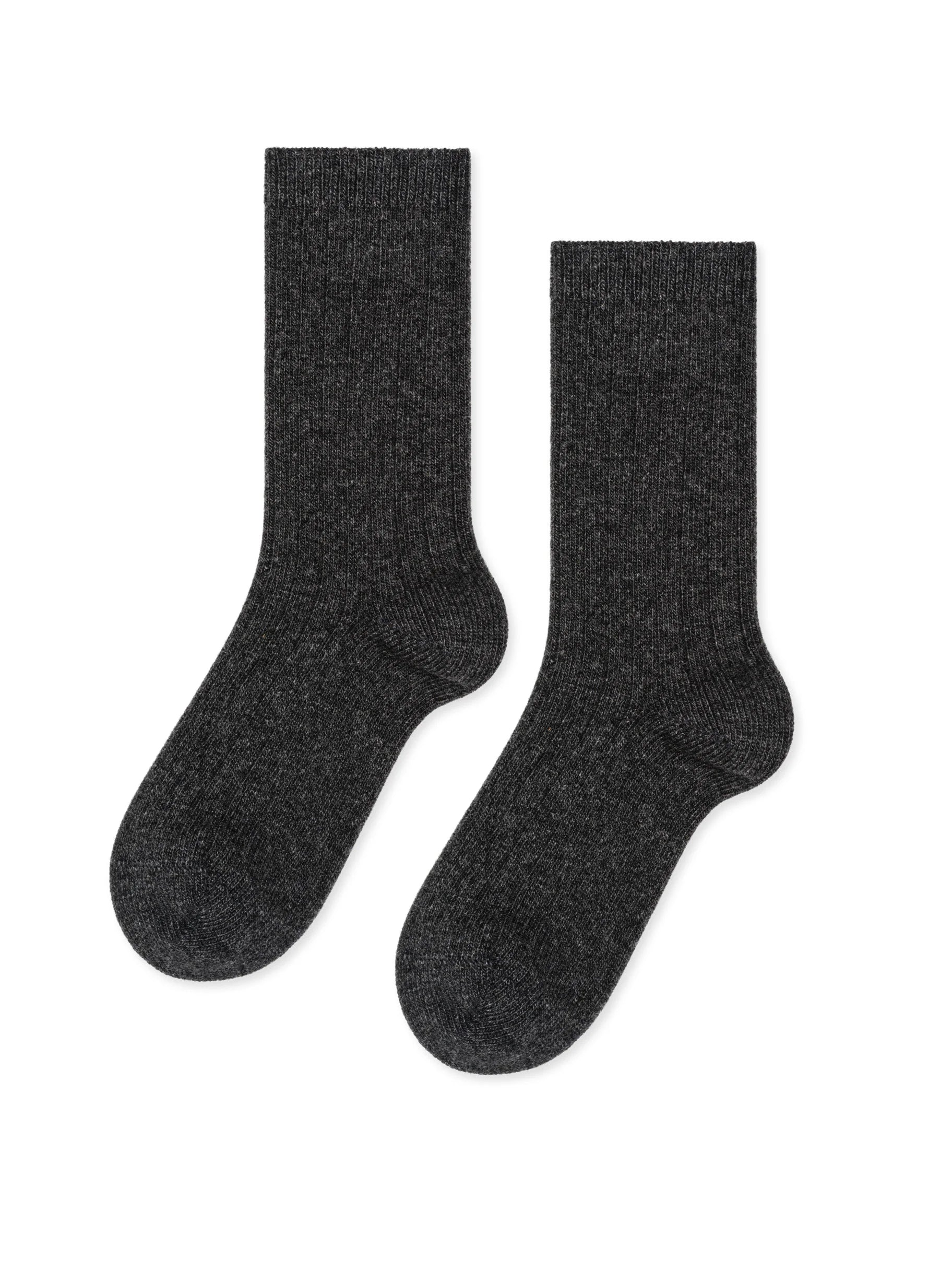 A pair of dark gray, heathered, ribbed knit crew socks, laid flat.