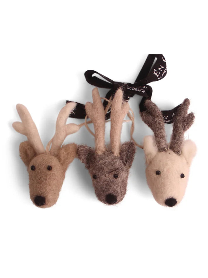 Three felt reindeer ornaments: light brown, dark brown, and cream, each with darker antlers and black eyes/noses.