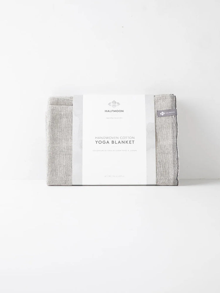 Here's alt text for the image, under 125 characters:
"Handwoven cotton yoga blanket, light gray, folded, with white...