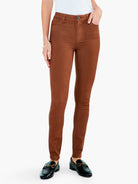 Rust brown slim-fit ankle pants. Features: front button, belt loops, and functional pockets.