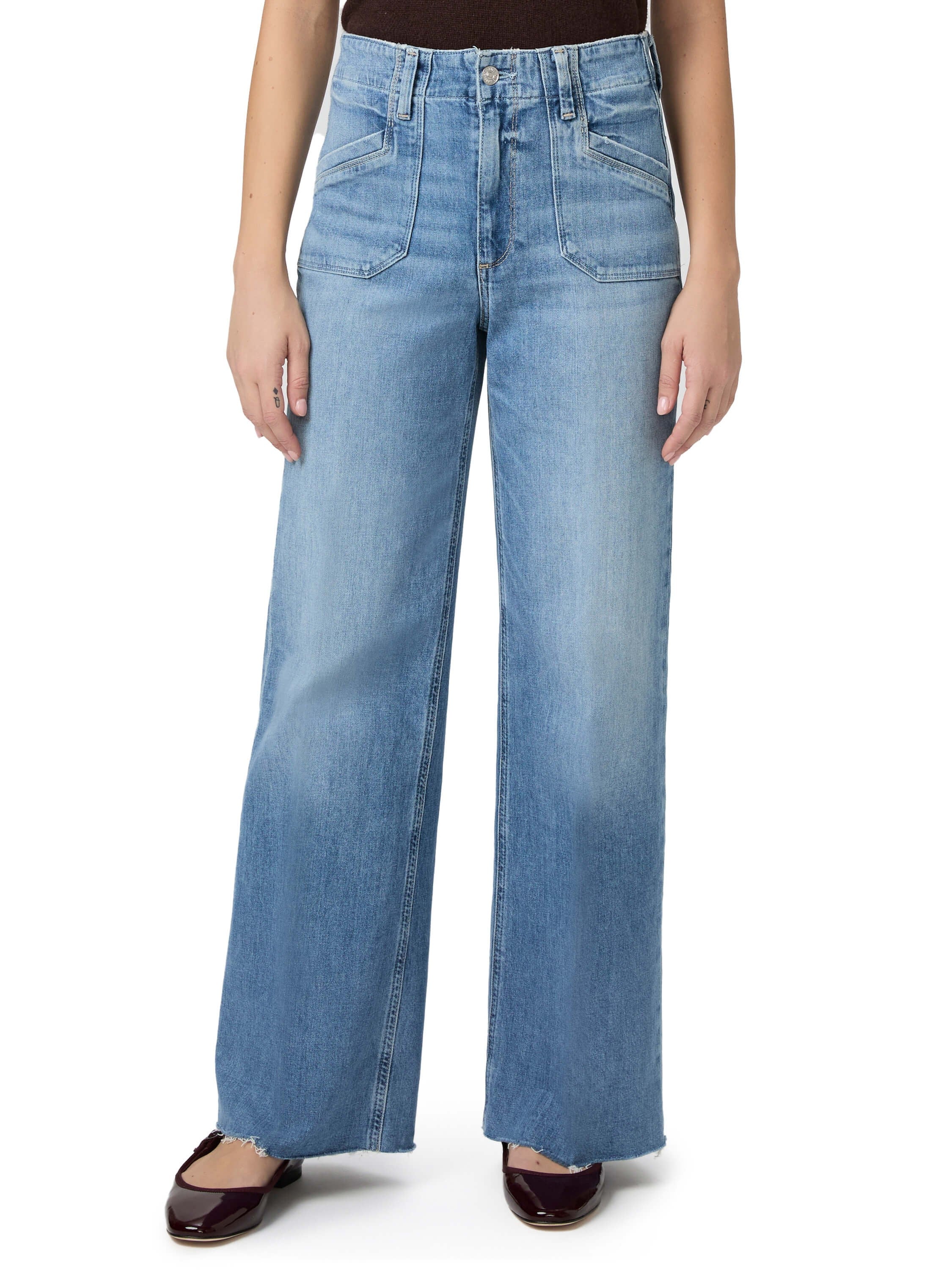 Light blue wide-leg jeans featuring large front patch pockets and a frayed hem.