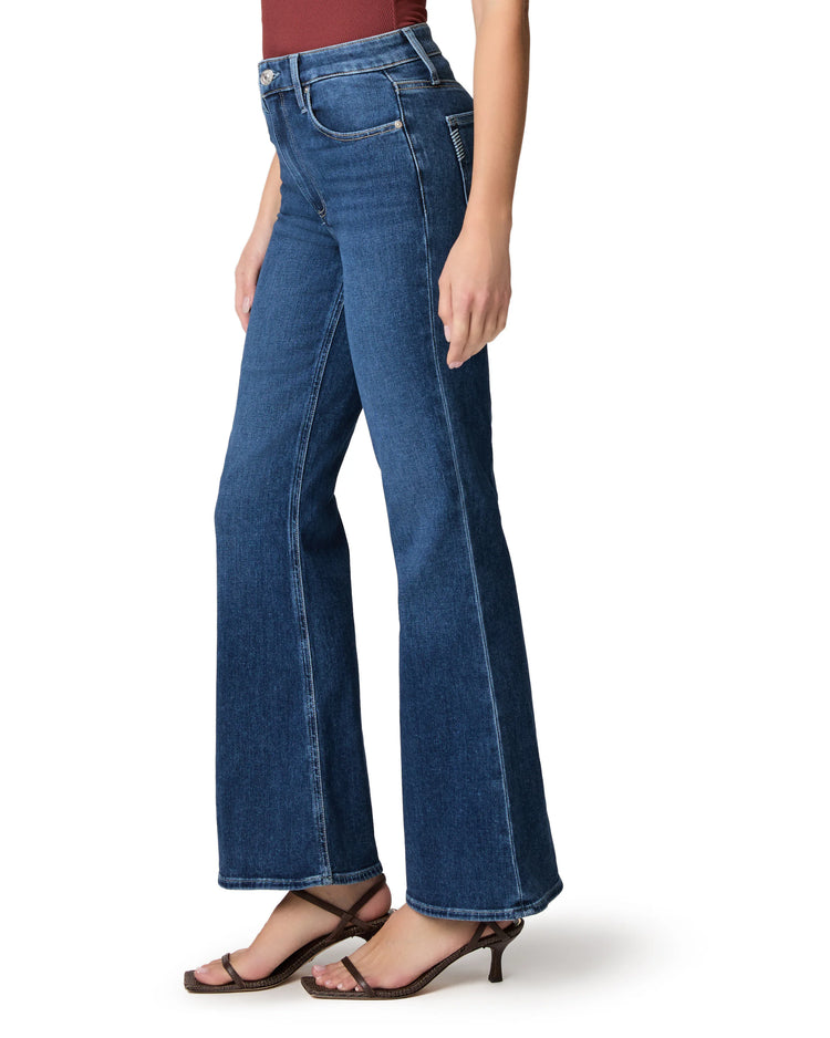 Dark blue high-waisted jeans with a subtle flare from the knee, covering the ankle.