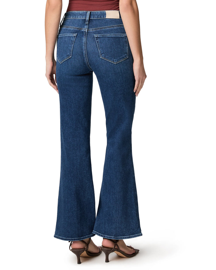 Dark blue high-waisted flared jeans with back pockets and a tan patch, cropped length.