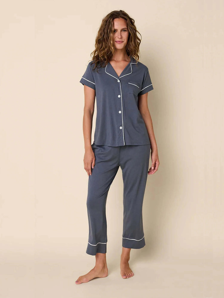 Here's alt text for the image, under 125 characters:
"Gray pajama set with white piping detail. Short-sleeved top with...