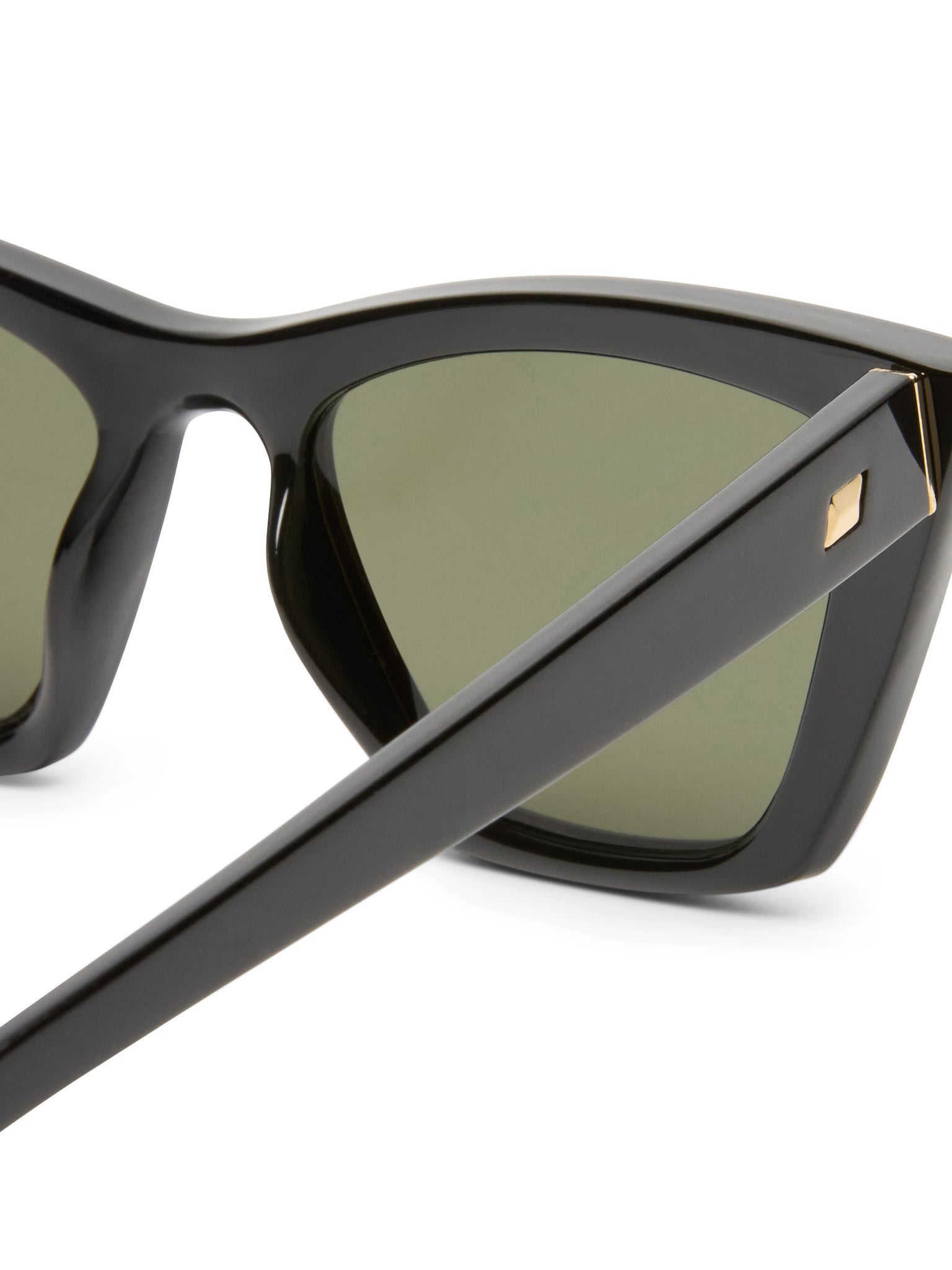 These black sunglasses feature thick frames with dark green lenses and a signature gold stud detail on the temple arm.