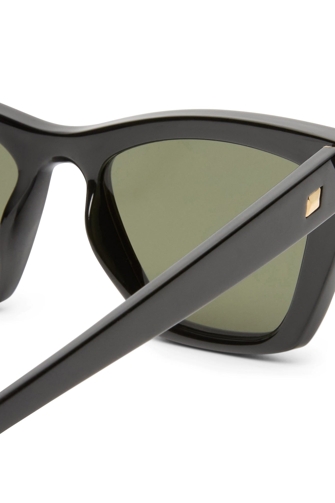 These black sunglasses feature thick frames with dark green lenses and a signature gold stud detail on the temple arm.