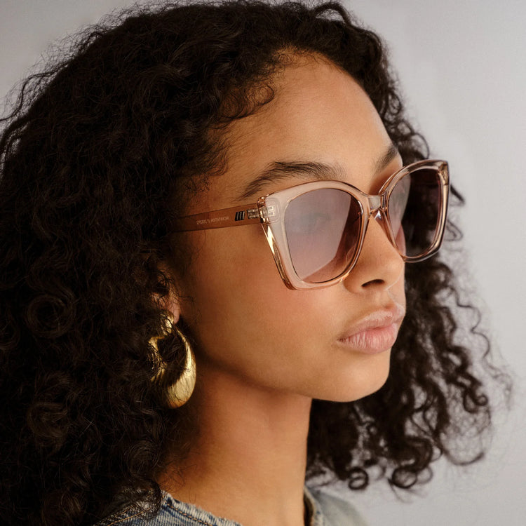 Oversized square sunglasses with translucent blush pink frames and gradient lenses for a stylish fit.