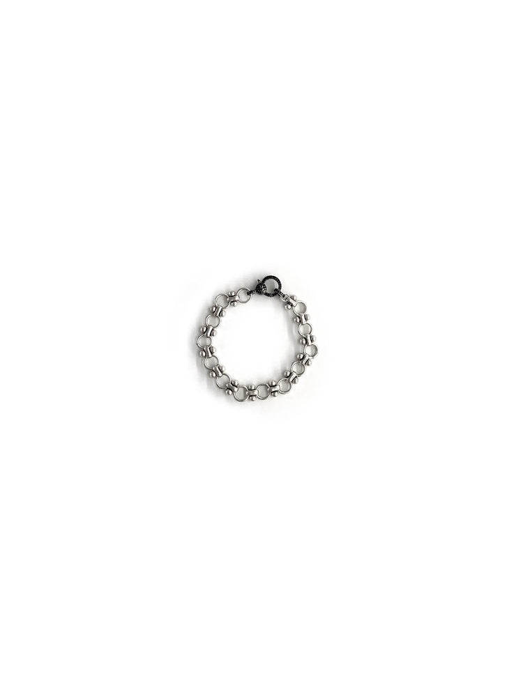 Silver bracelet with dark clasp; linked chain design with small beads.