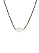 Dark metallic faceted beads choker with a large, off-white iridescent baroque pearl in the center.
