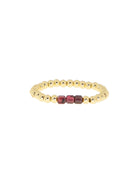 Gold beaded ring with three central dark red rectangular glass beads.