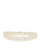 Cream faceted beads on a three-strand bracelet with a center elongated white pearl.