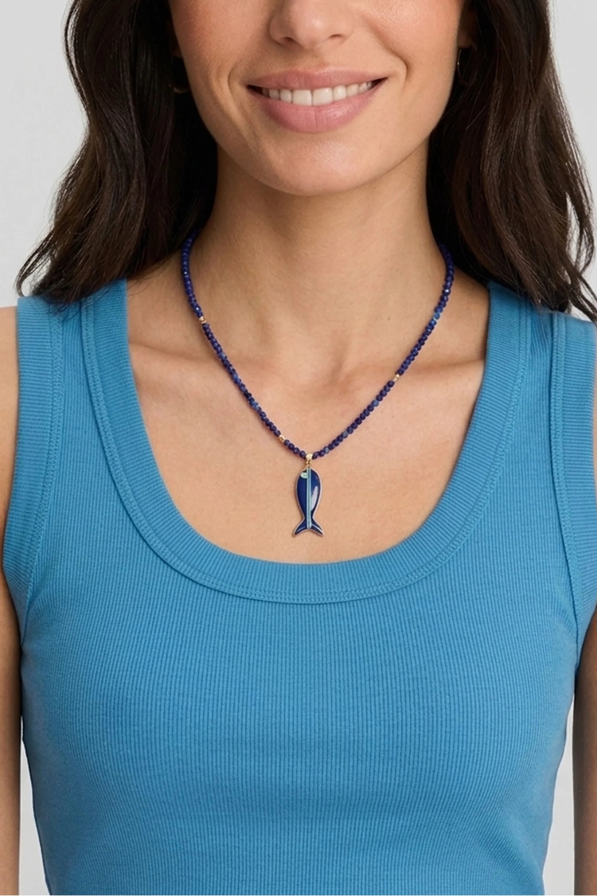 Lapis beaded necklace with dark blue fish pendant, light blue stripe, green accent, and gold details.
