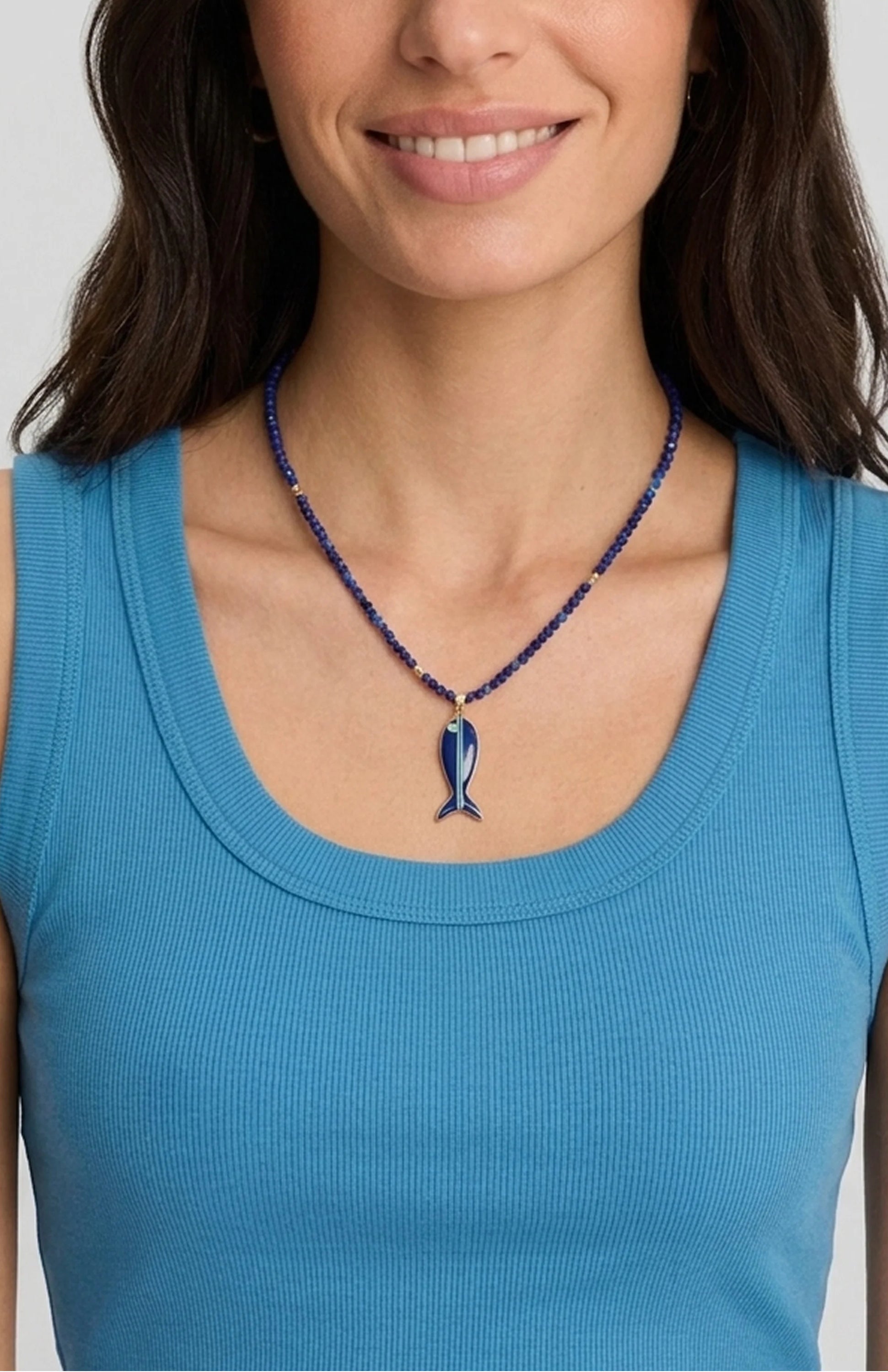 Lapis beaded necklace with dark blue fish pendant, light blue stripe, green accent, and gold details.
