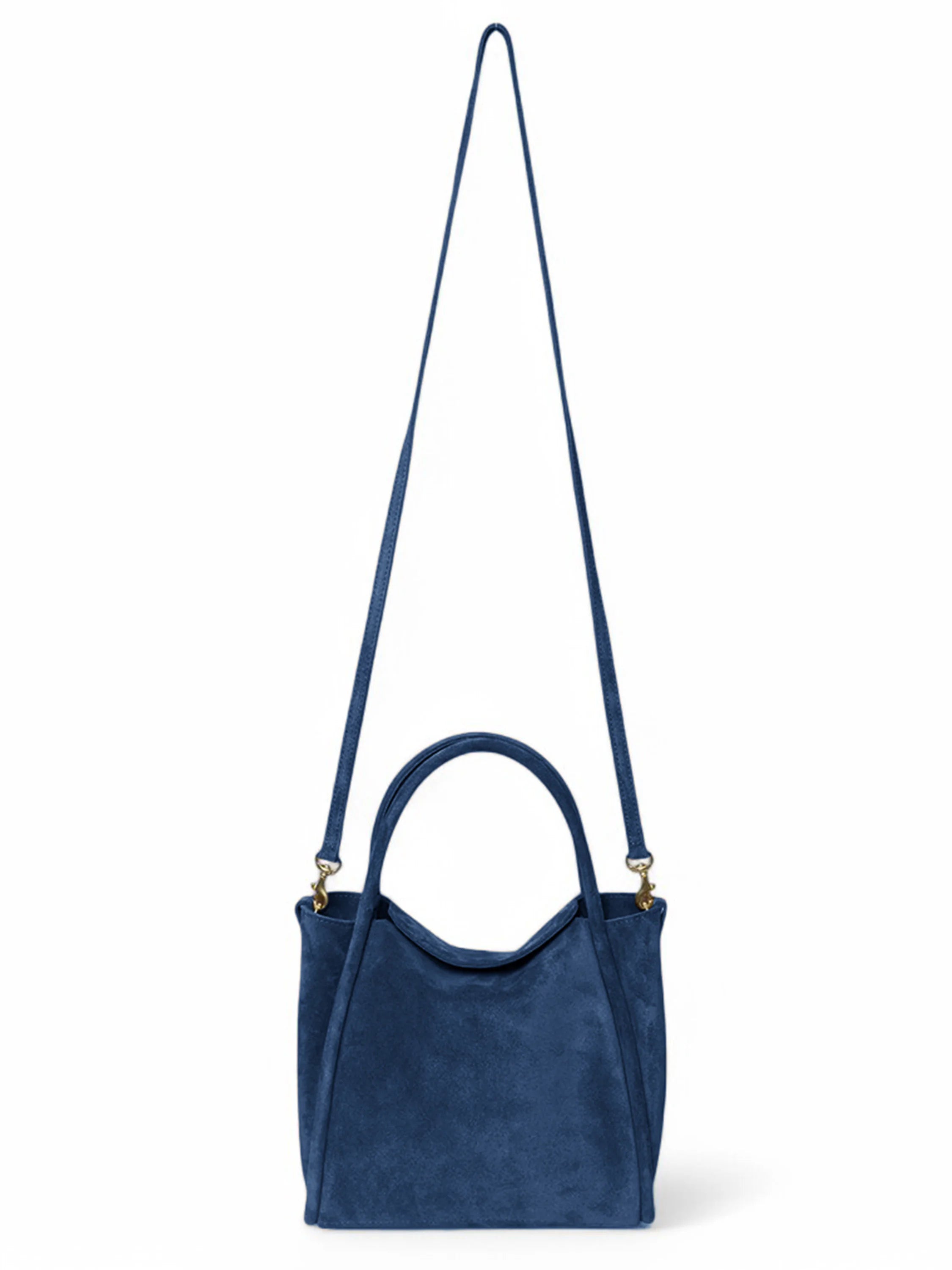 Dark blue suede satchel bag with gold-tone hardware and long shoulder strap.