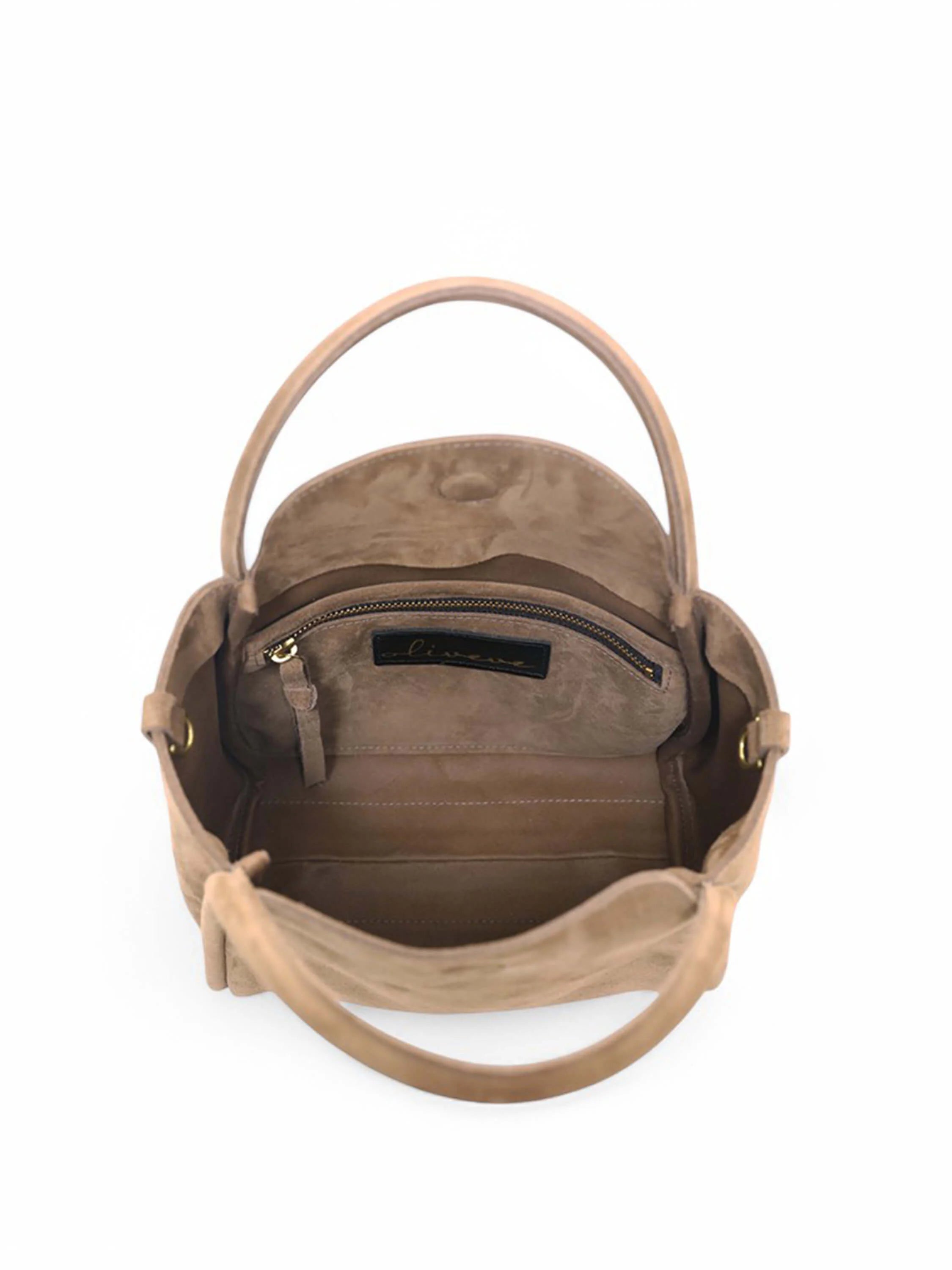 Beige suede satchel bag, top view. Interior shows taupe lining, small zippered pocket, and gold-toned hardware.