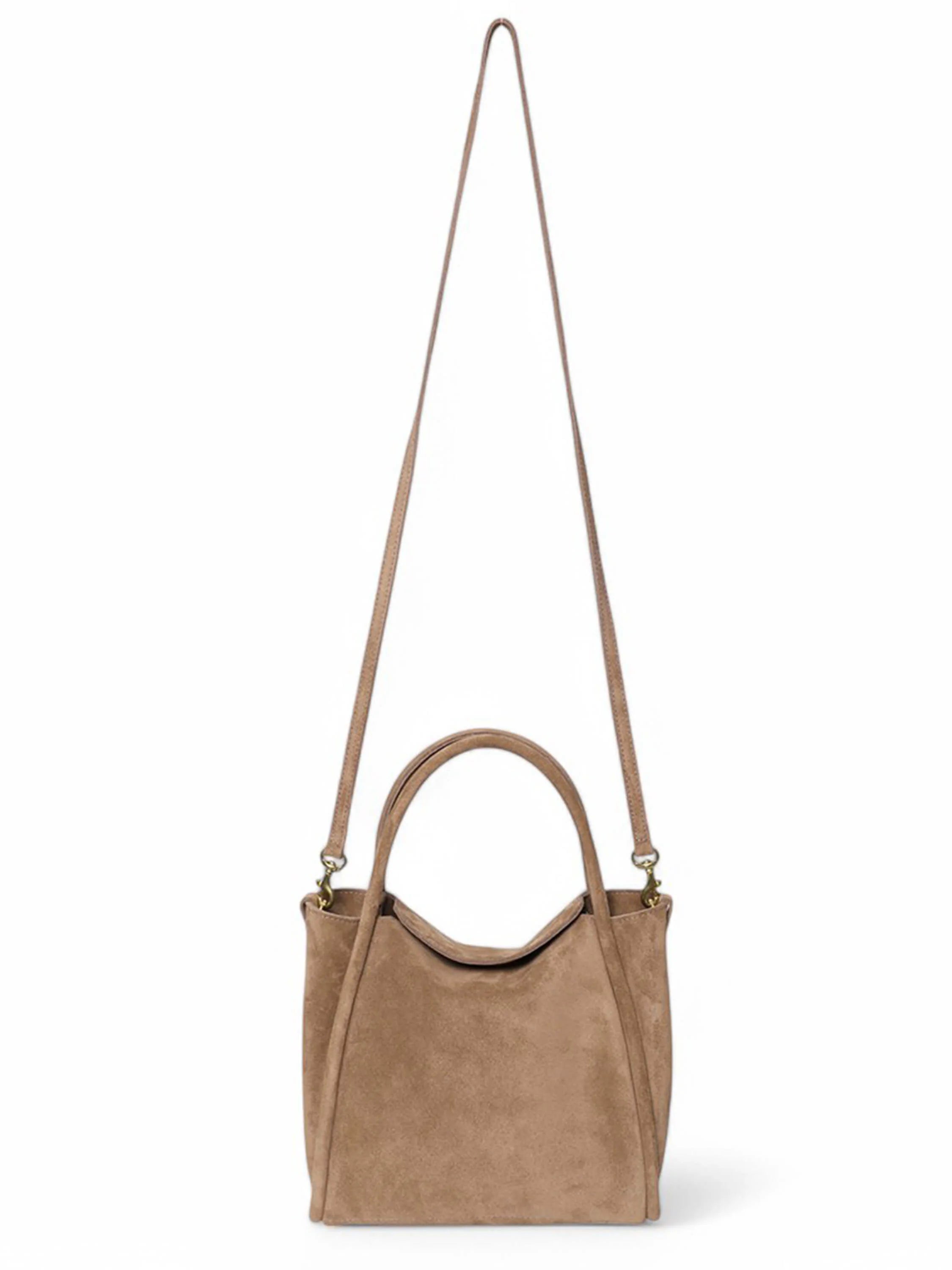 Beige suede satchel bag with long shoulder strap and top handles; gold-toned hardware.