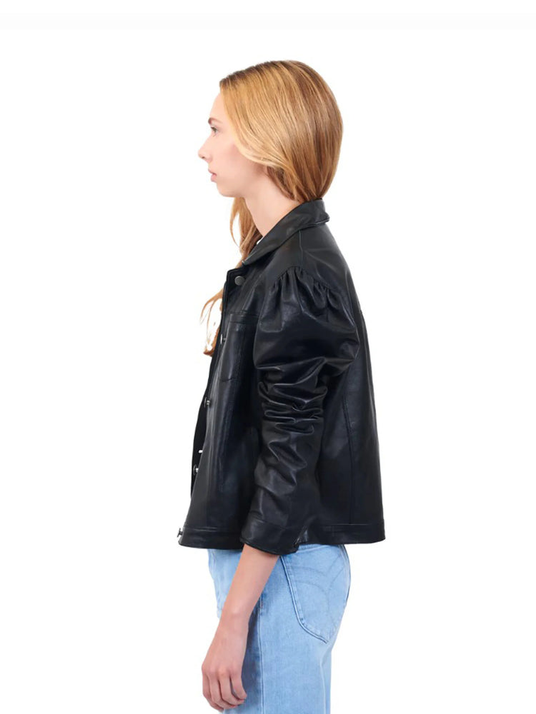 Black leather jacket, peplum hem, puffed sleeves. Side profile view.