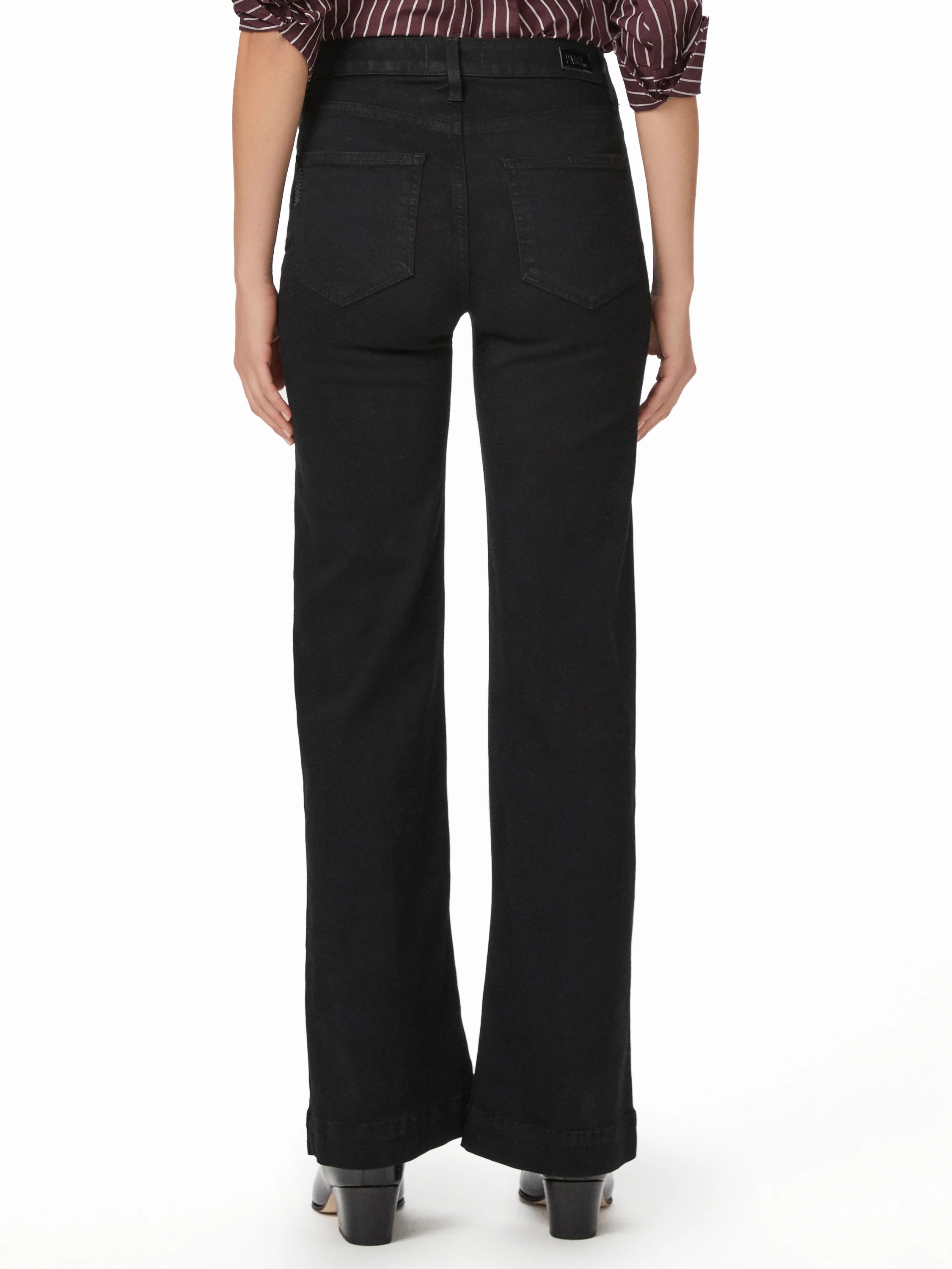 Black Paige Leenah jeans, rear view. High-waisted, wide-leg, two back pockets, and a cuffed hem.