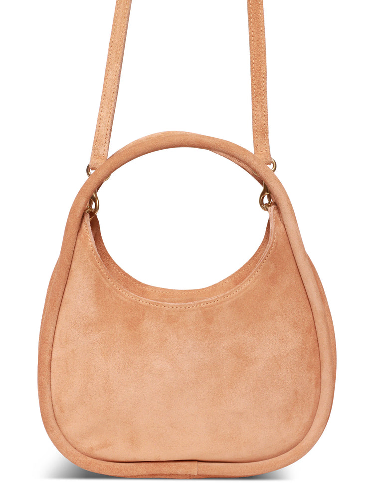 Light beige suede crossbody bag with a circular top handle and thin shoulder strap. Gold-toned hardware.
