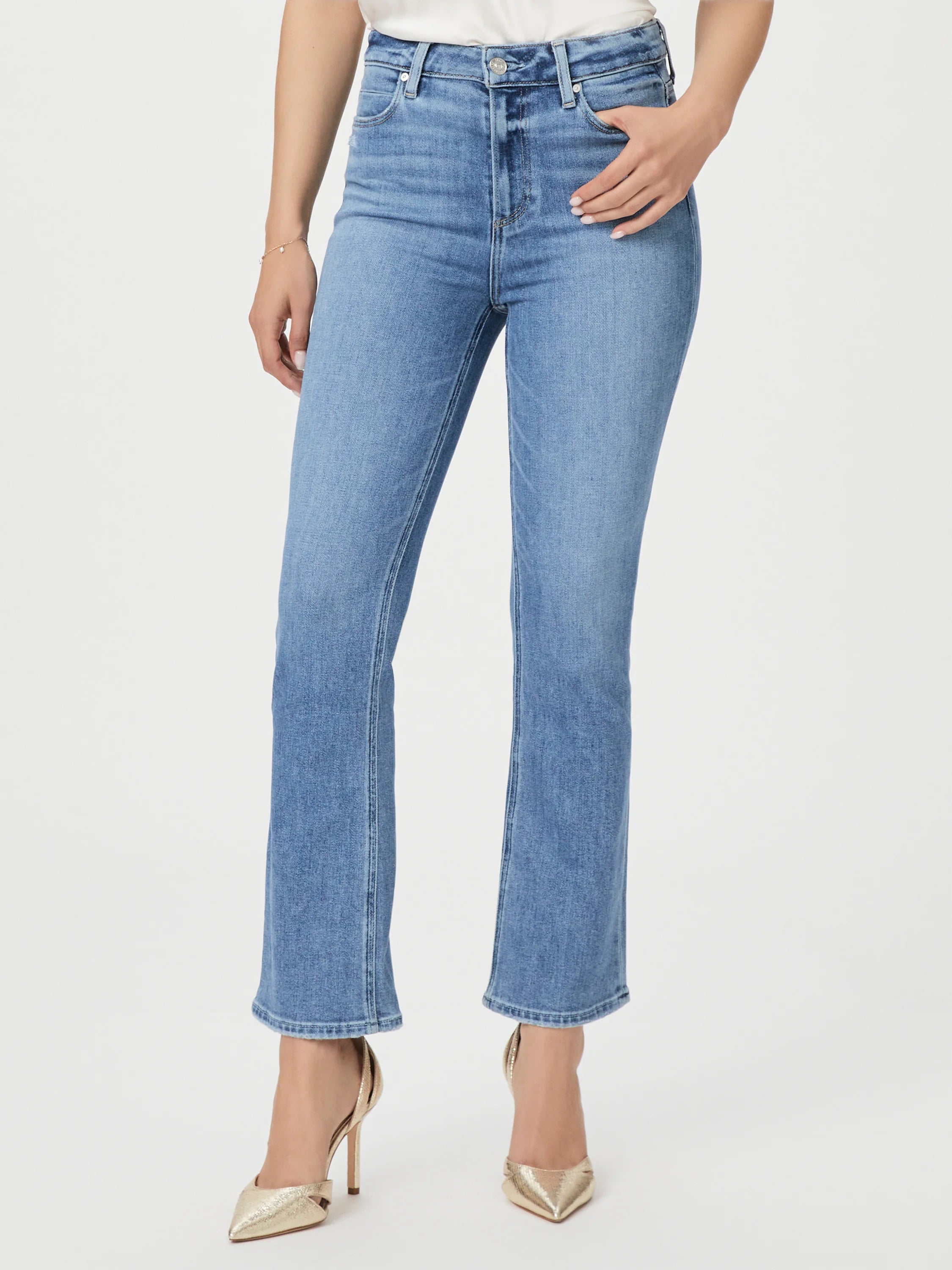 Light wash, bootcut jeans with a linear coin pocket. Features visible stitching.