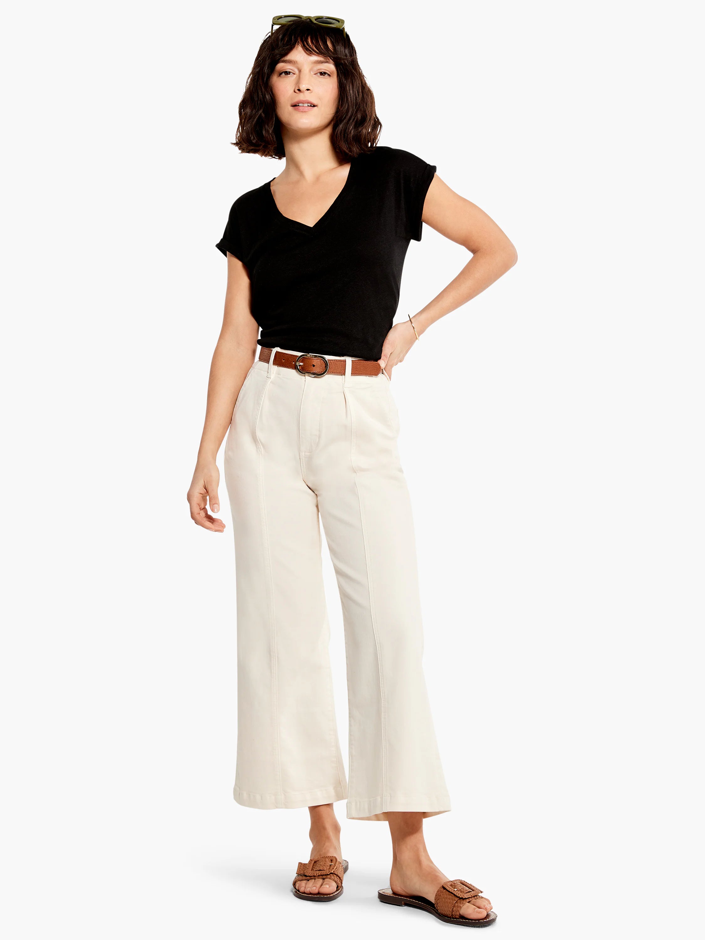 Off-white, wide-leg cropped jeans; high-waisted with a brown belt.