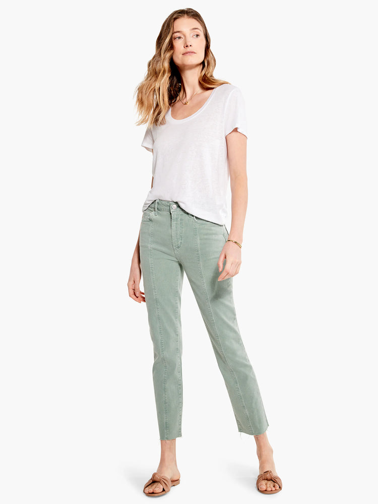 Sage green cropped jeans, front seams, raw hem. Model wears white shirt & brown sandals.