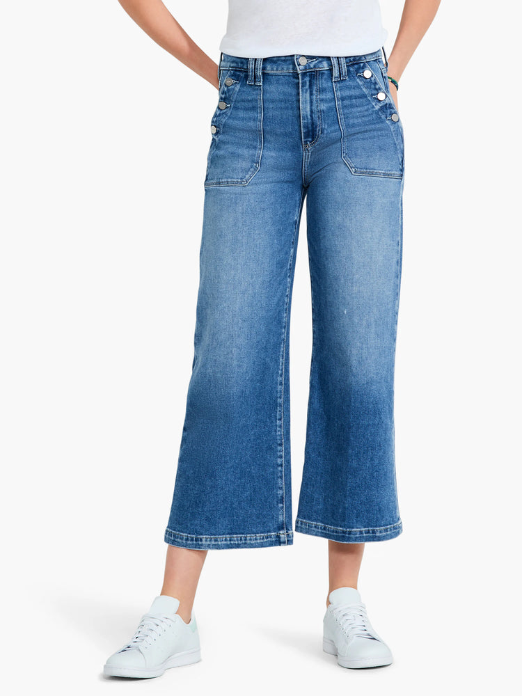 Here's alt text for the image, under 125 characters:
Mid-wash blue, wide-leg cropped jeans with silver buttons and patch...
