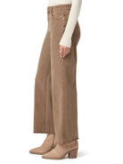 Brown high-waisted, wide-leg jeans with a raw hem. Modeled.