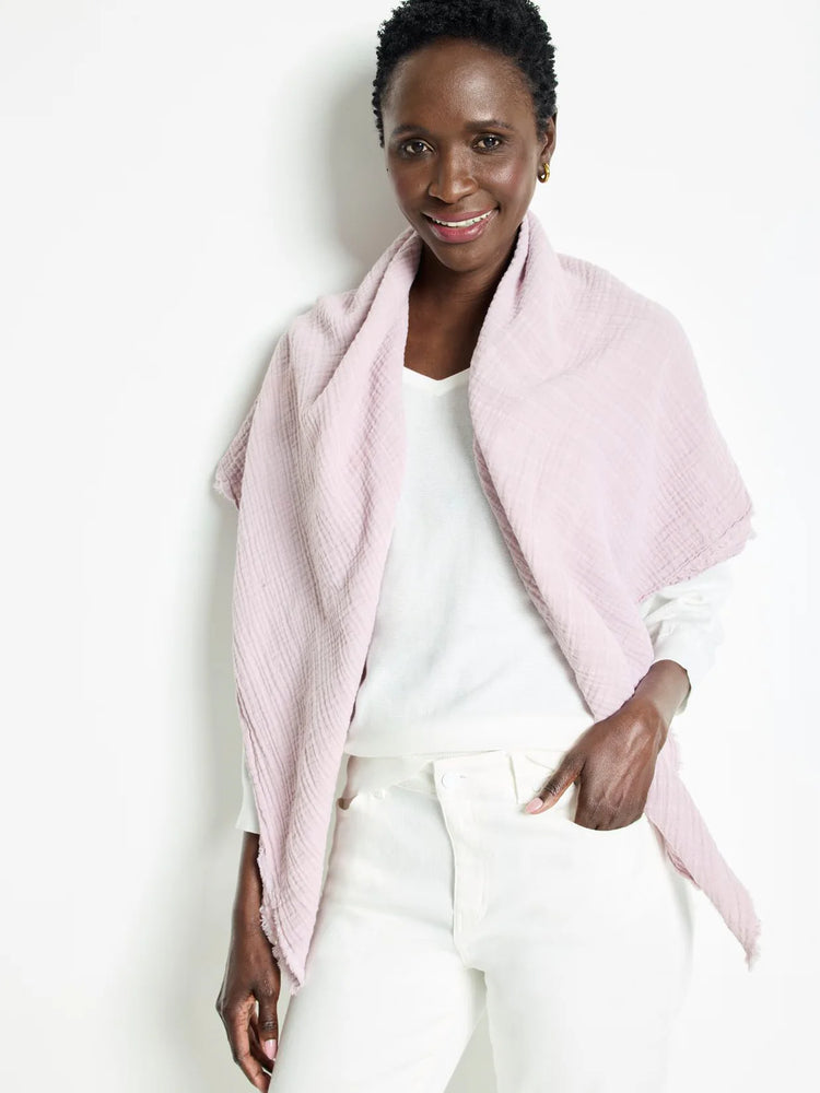 Light pink double gauze scarf; textured fabric, slightly frayed edges.