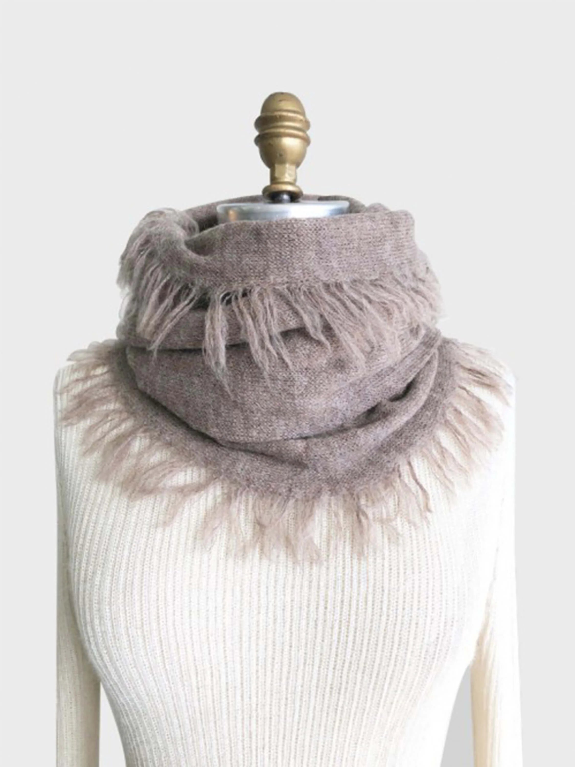 Taupe alpaca scarf with fringed edges. Shown draped on a light beige mannequin.