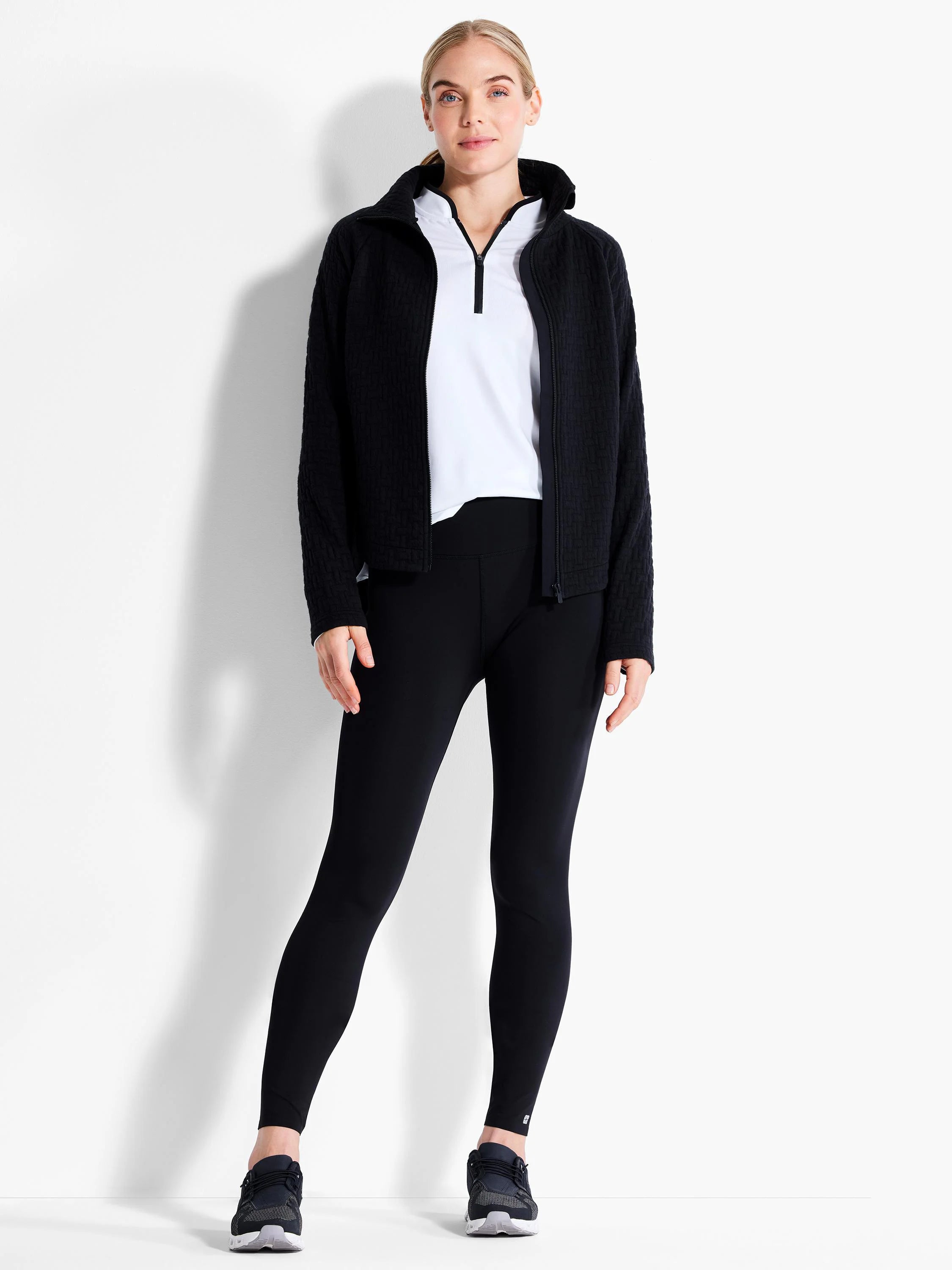 Black quilted full-zip jacket with a stand collar.