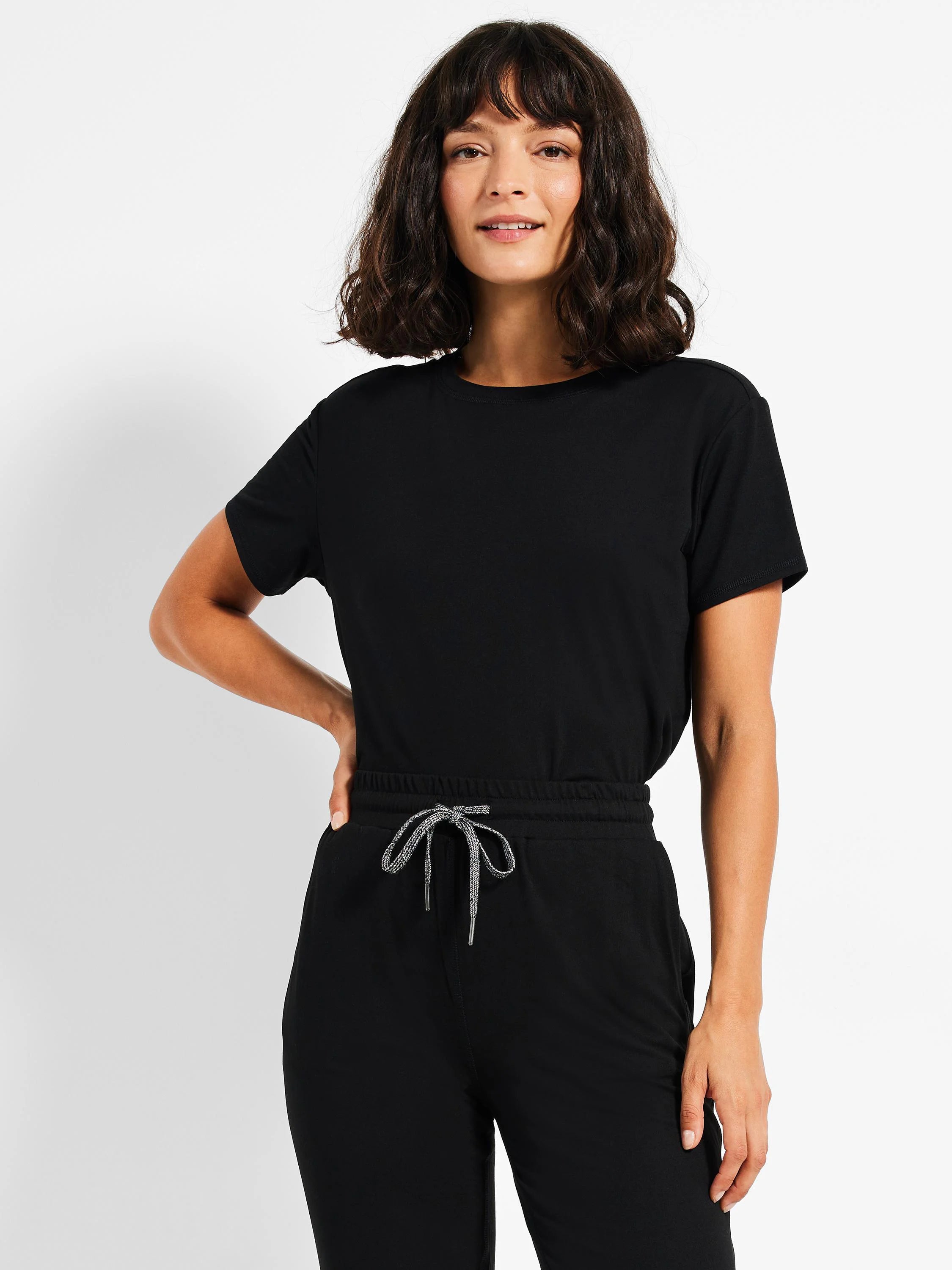 Black joggers with an elastic waistband and drawstring. The drawstring is a grey and white pattern.