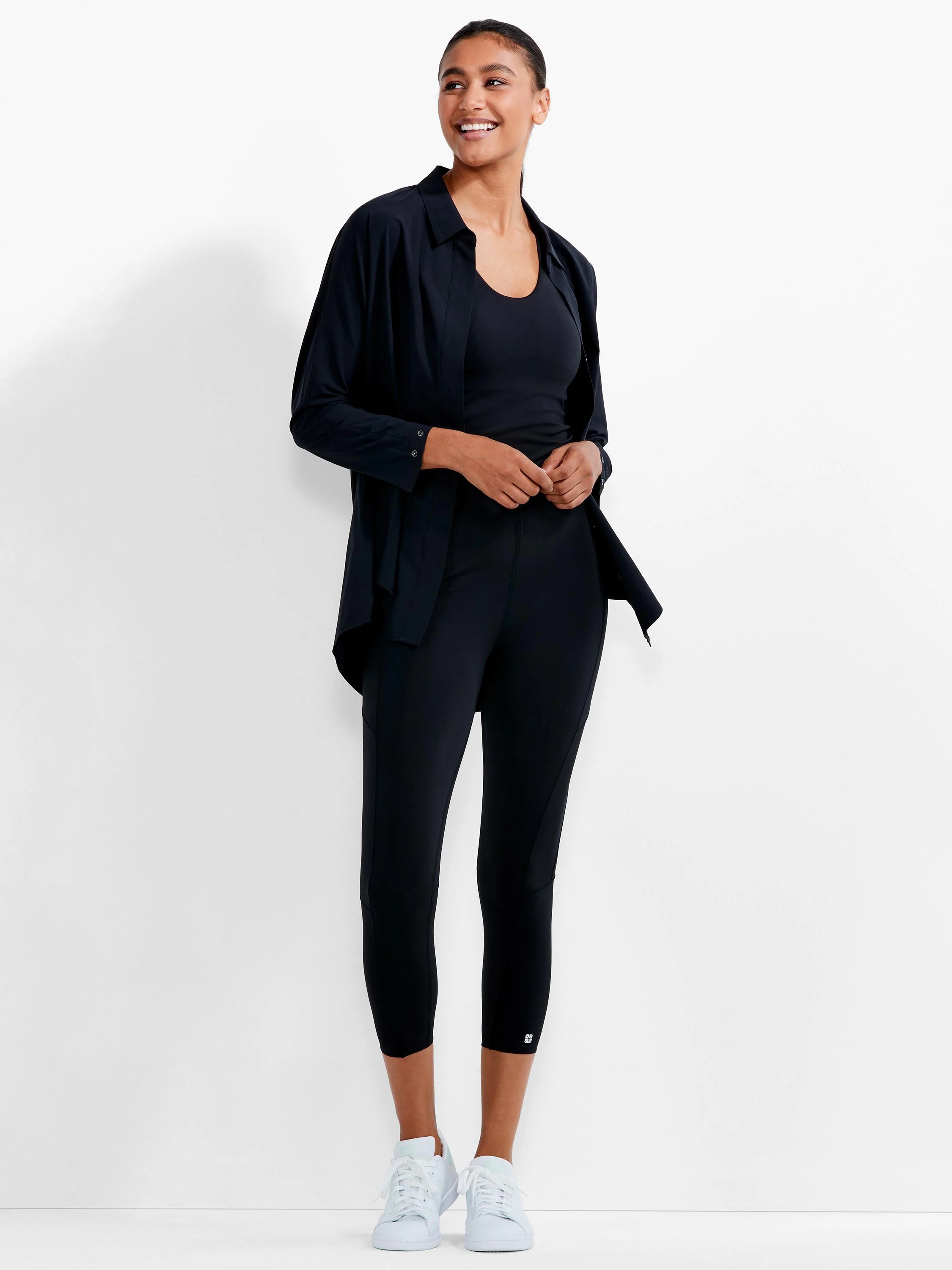 Black collared button-down Tech Stretch Shirt, worn open with long sleeves and a loose, lightweight drape.