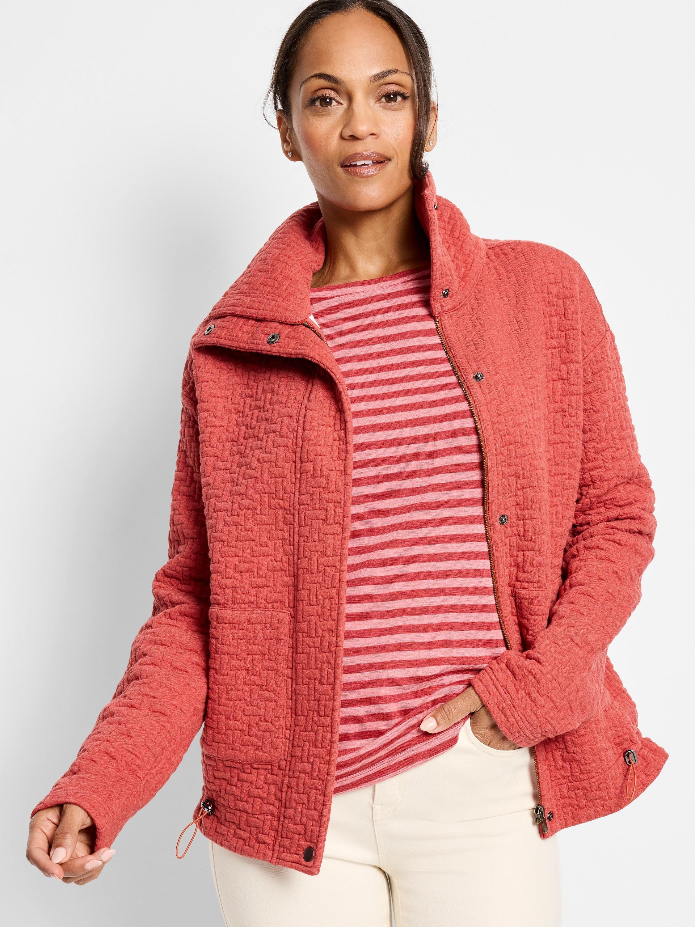 Coral quilted jacket with a high collar, zipper, and snap closures. Textured fabric. Side pockets.