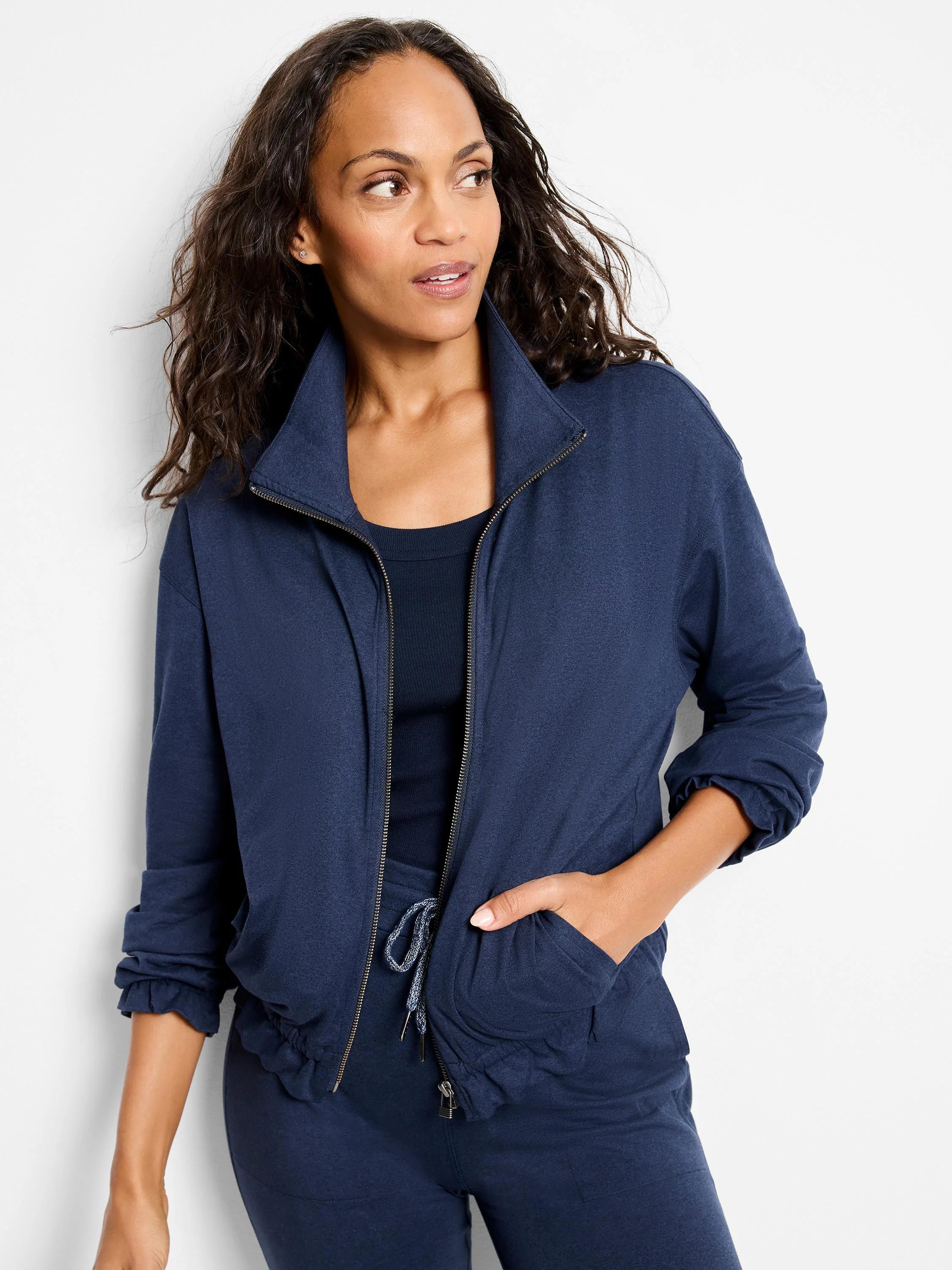 Navy blue zip-front jacket with slightly gathered cuffs and hem. Features pockets and a drawstring waist.