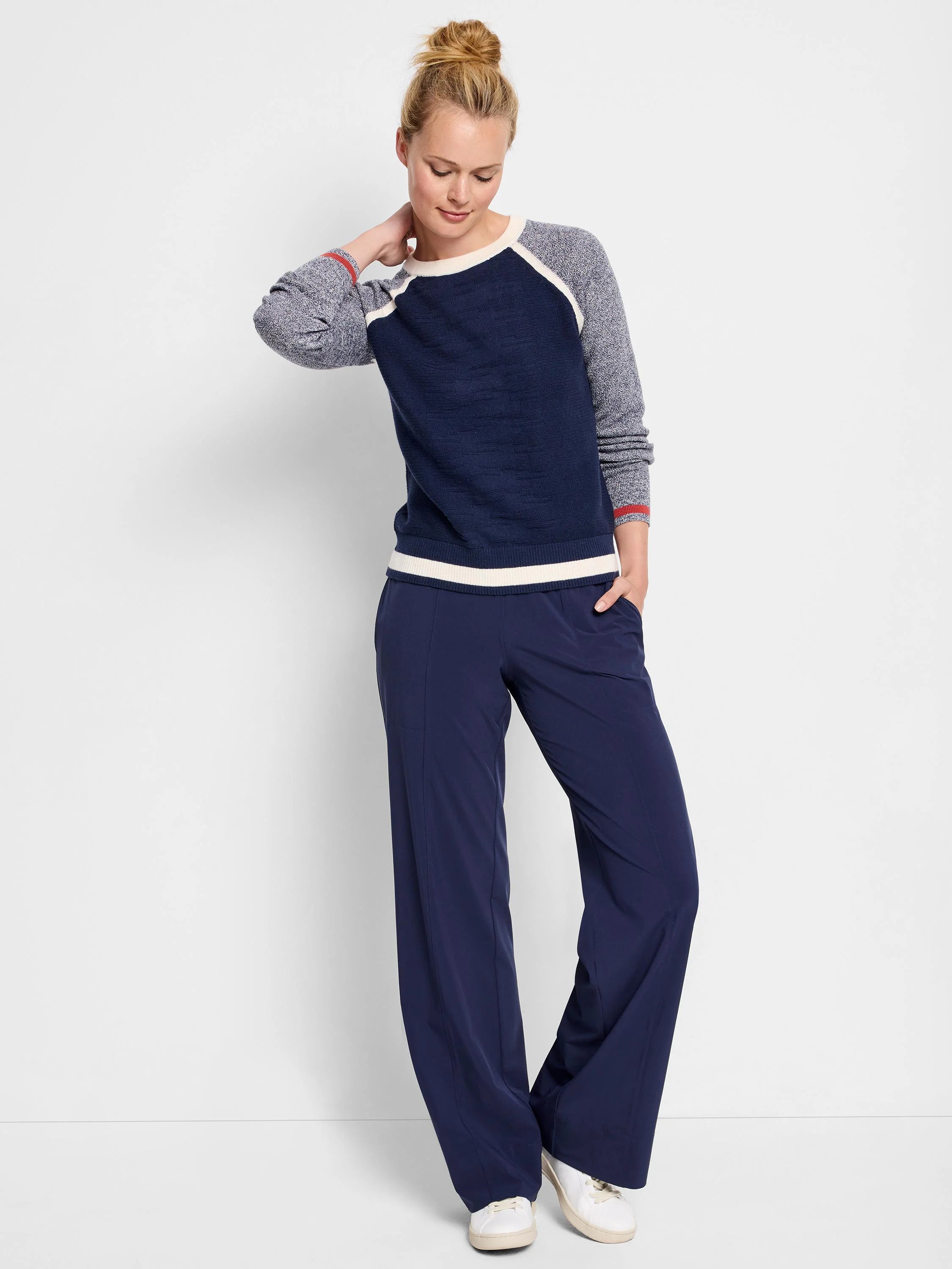 Navy blue sweater with gray and white raglan sleeves and trim. Red detail on cuffs.