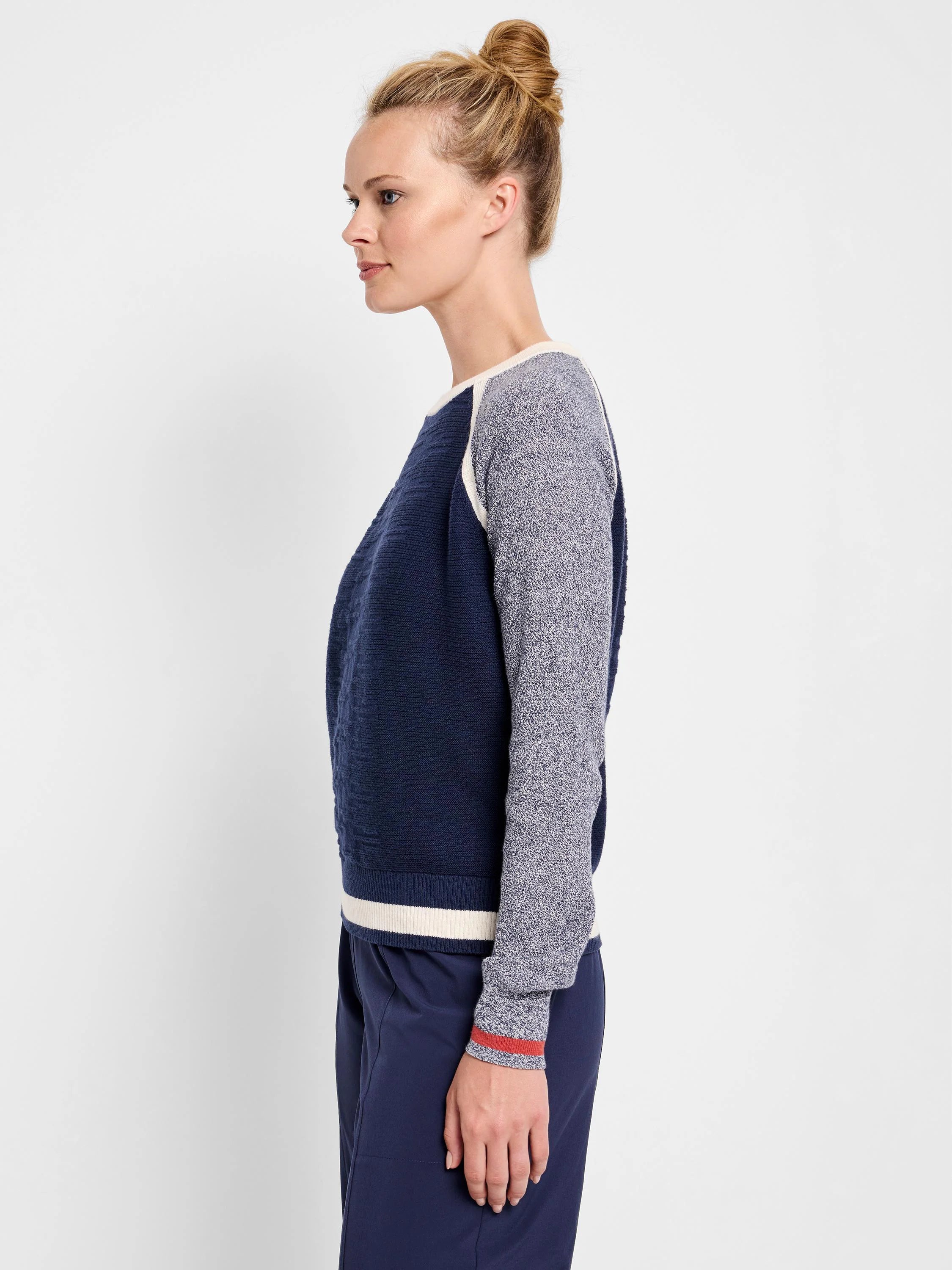 Navy blue sweater with off-white and grey speckled sleeves and bottom band. Features a cream colored yoke. Red trim on...