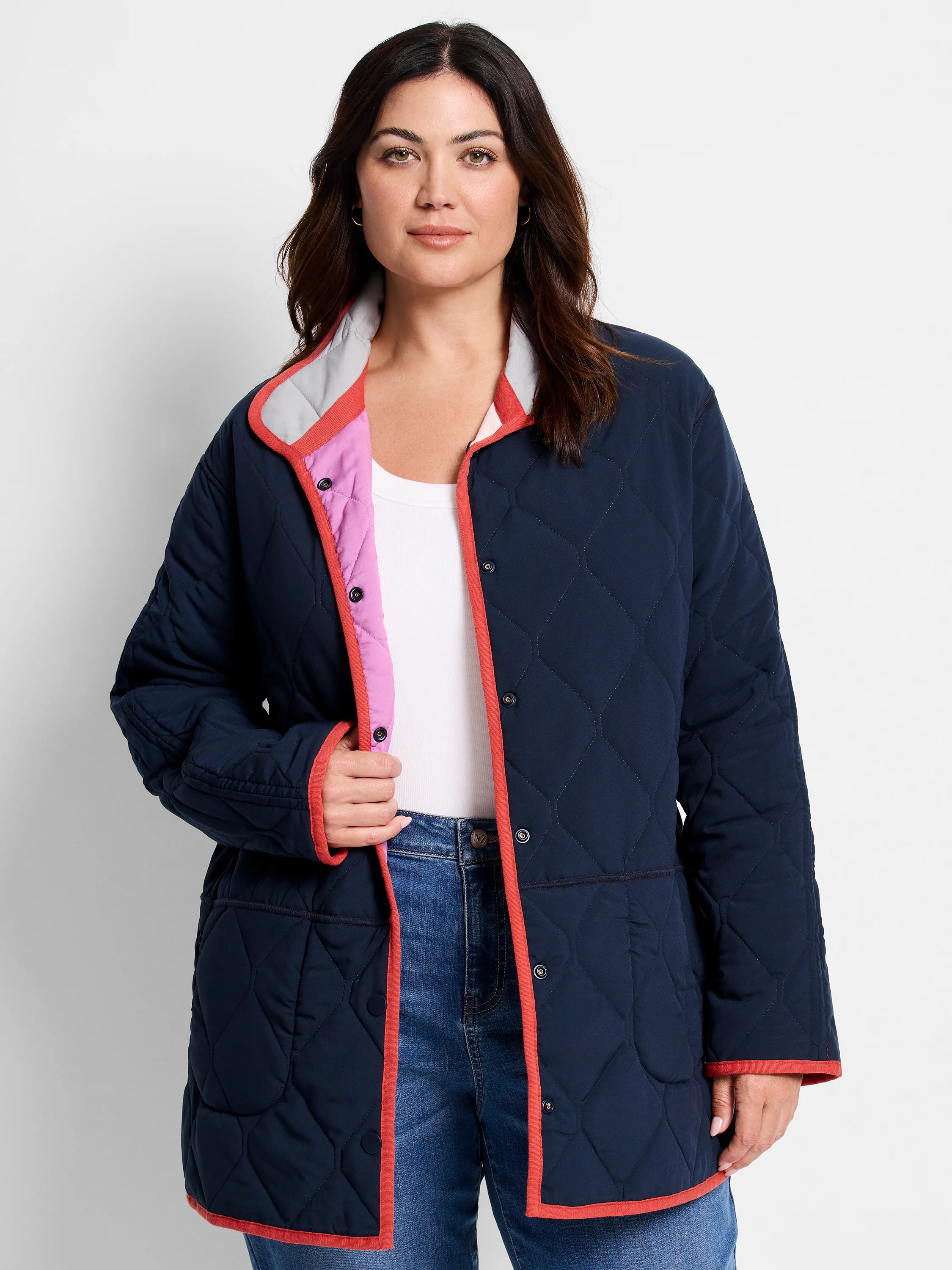 Navy diamond-quilted reversible coat with coral trim. Features pink interior and grey collar.