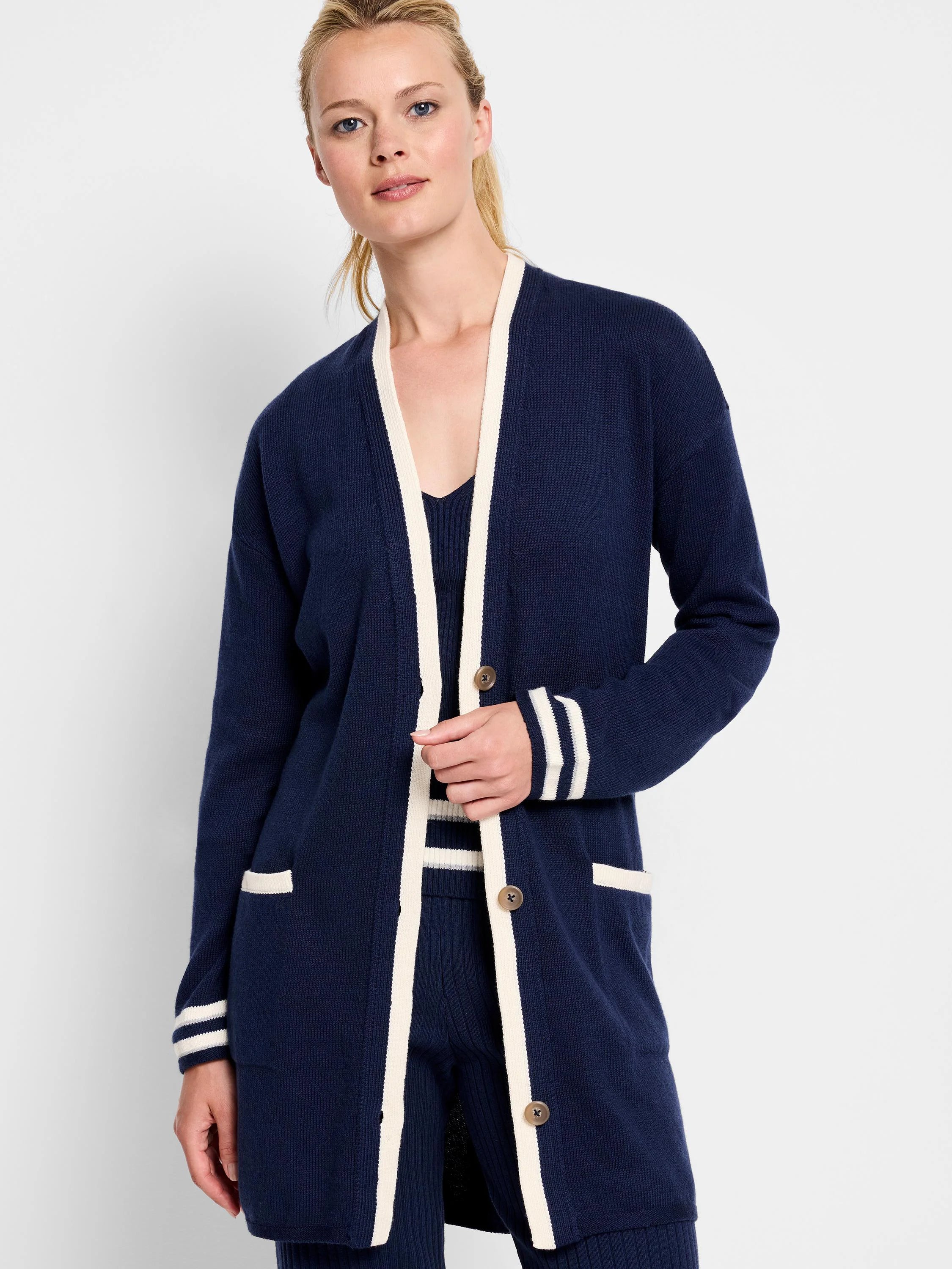 Navy blue cardigan with cream trim on placket, cuffs, and pockets. Button front.