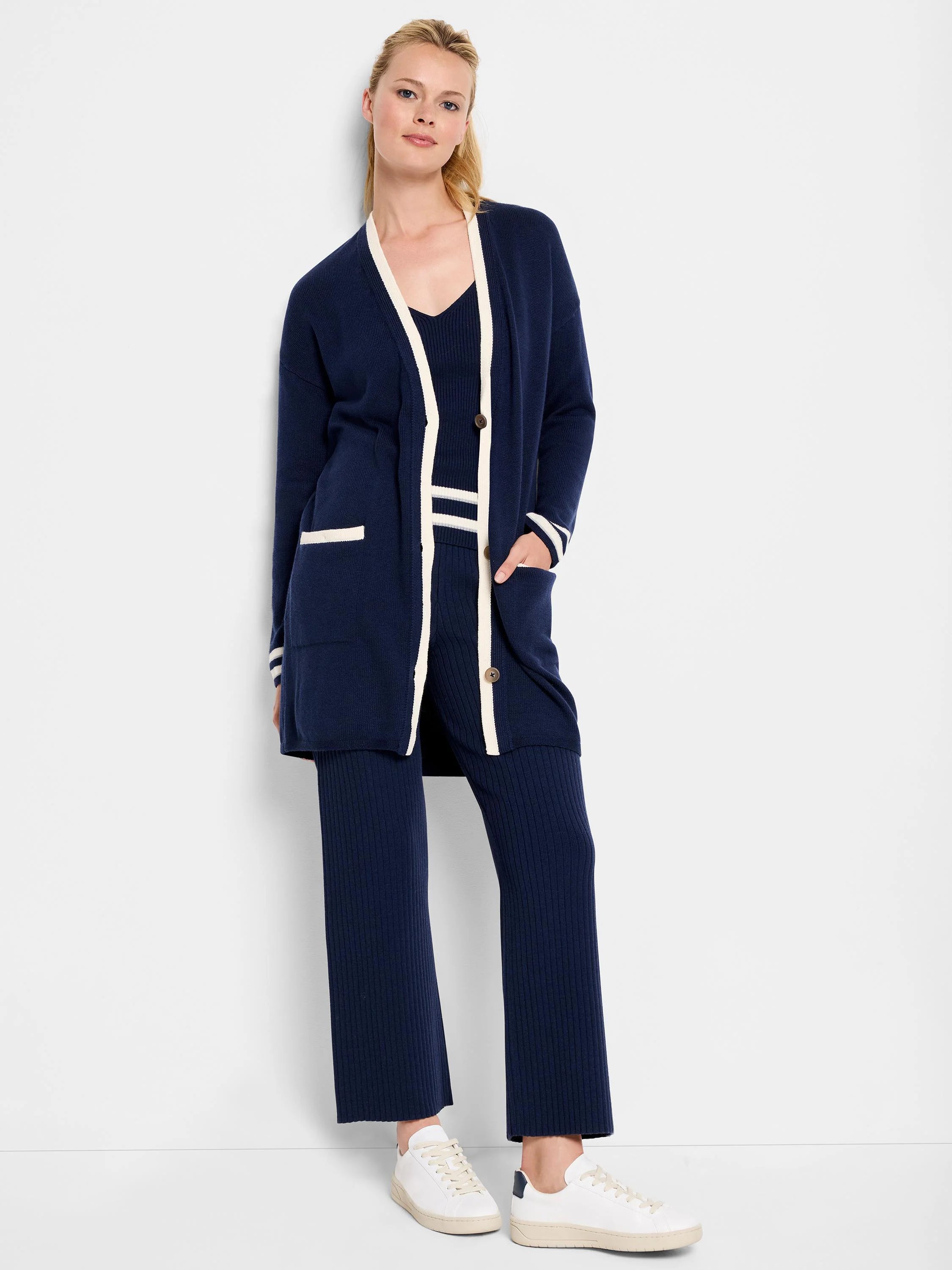 Navy blue cardigan with cream trim, pockets, and buttons. Matching ribbed pants.