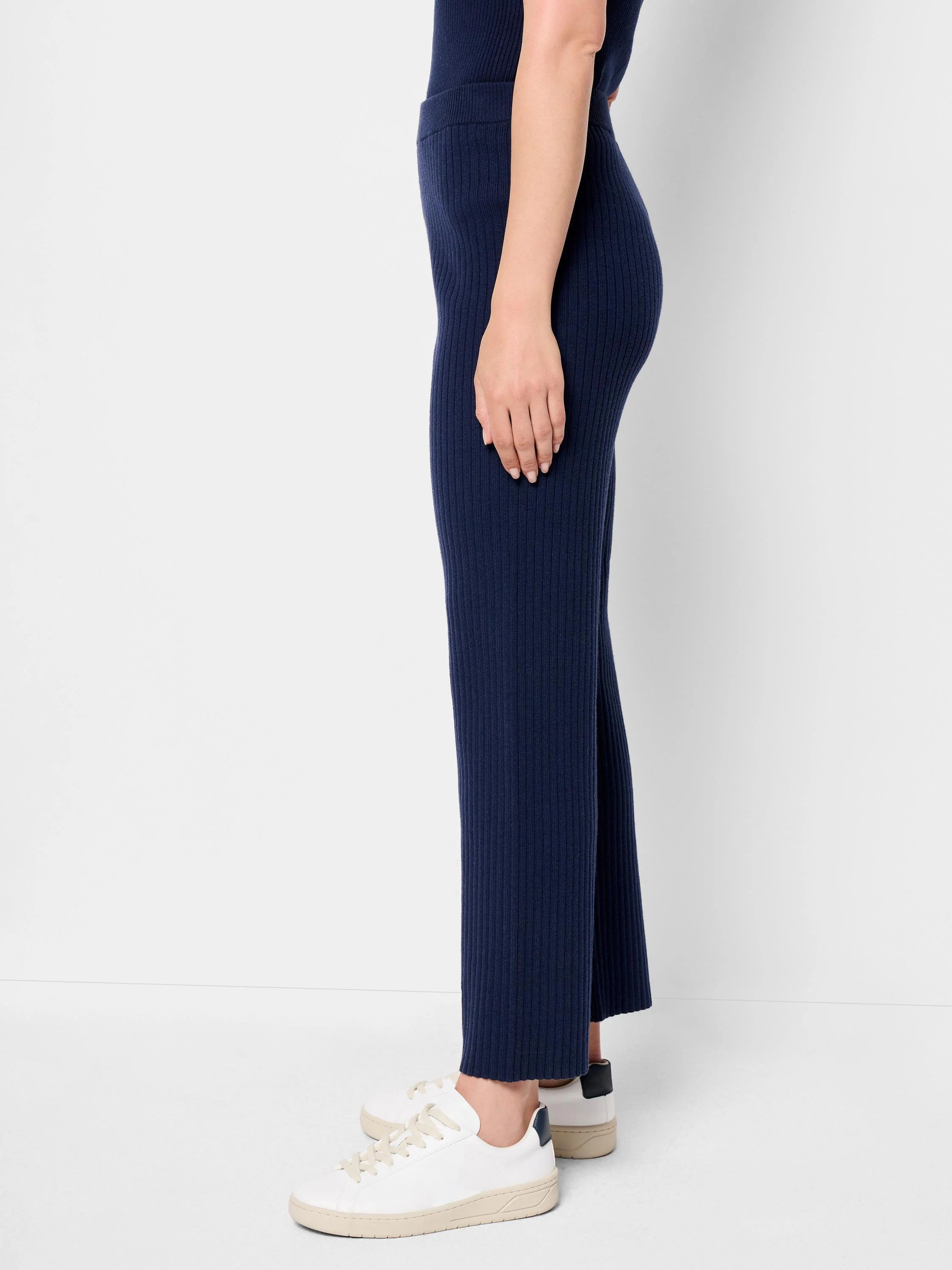 Dark navy blue ribbed knit pants, cropped, shown on a model.
