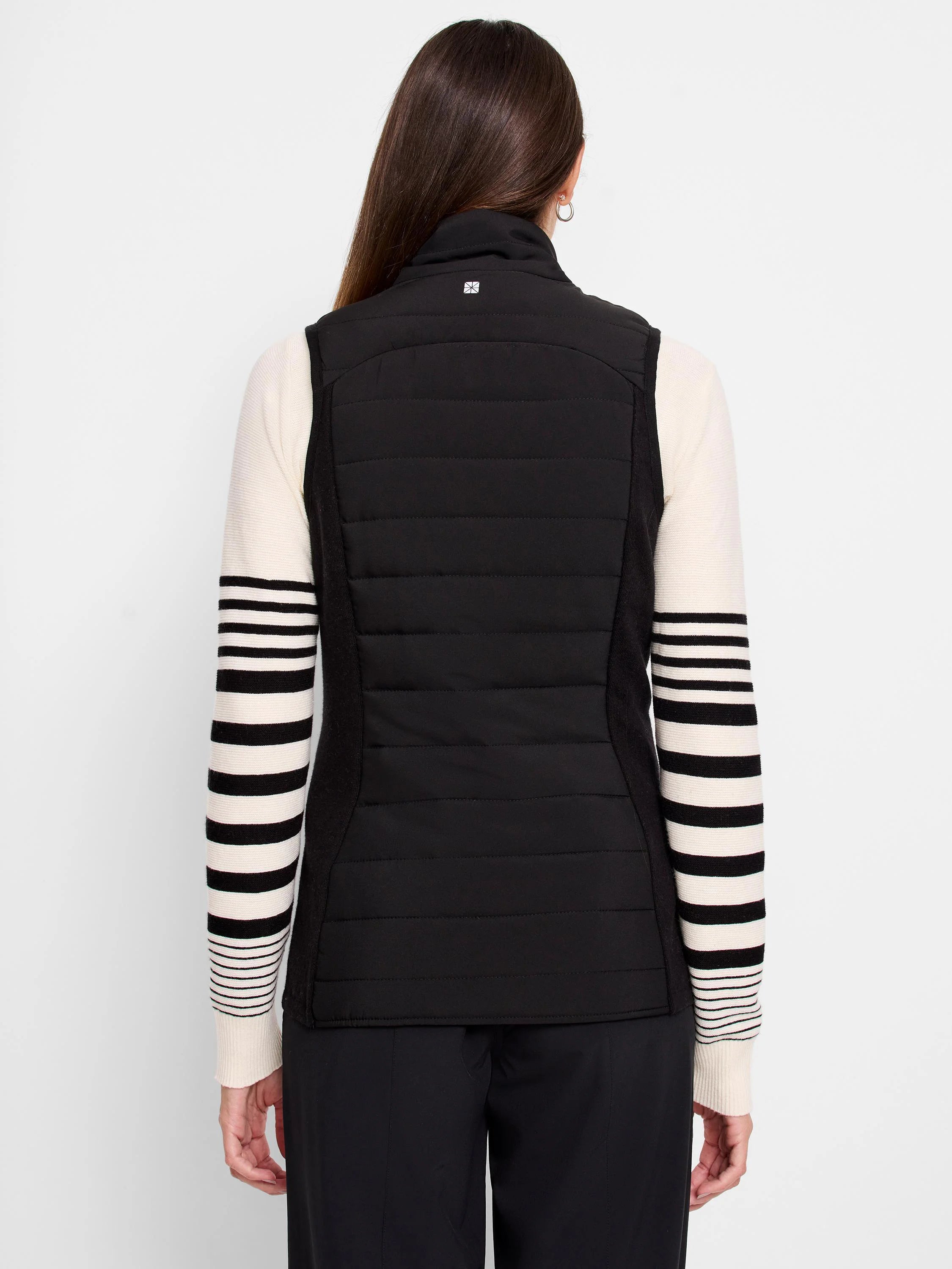 Black quilted puffer vest with knit trim. The trim is off-white with thin black stripes. Back view.