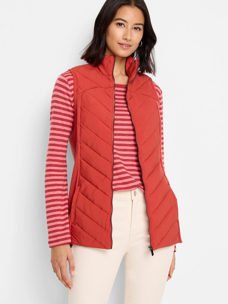 Red quilted puffer vest with a zipper front. Features chevron quilting and knit trim.