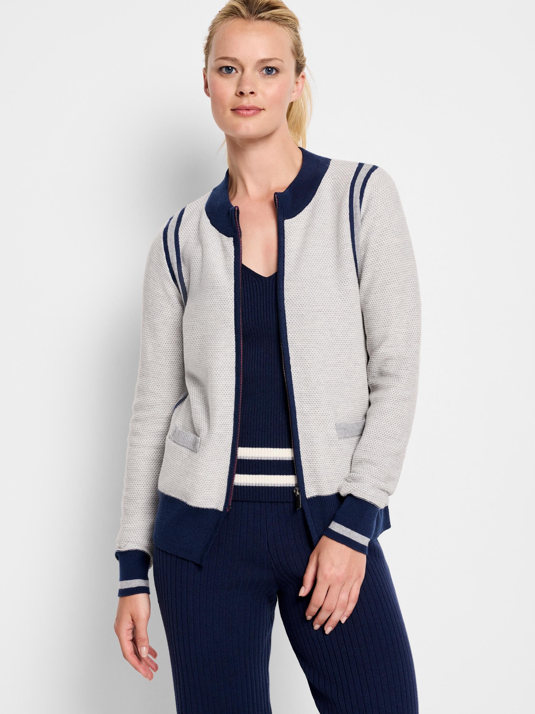 Zip-front light gray cardigan with navy and gray stripes at shoulders and cuffs. Navy bottom trim.