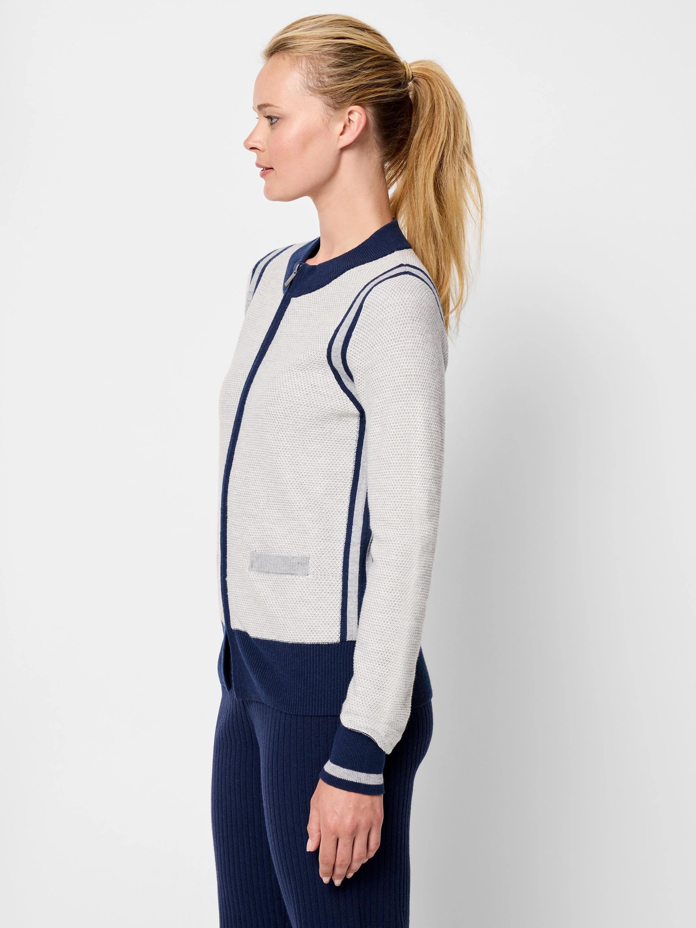 Zip-front cardigan; light gray body with navy blue and light gray stripes. Navy blue bottom band and cuffs with light...