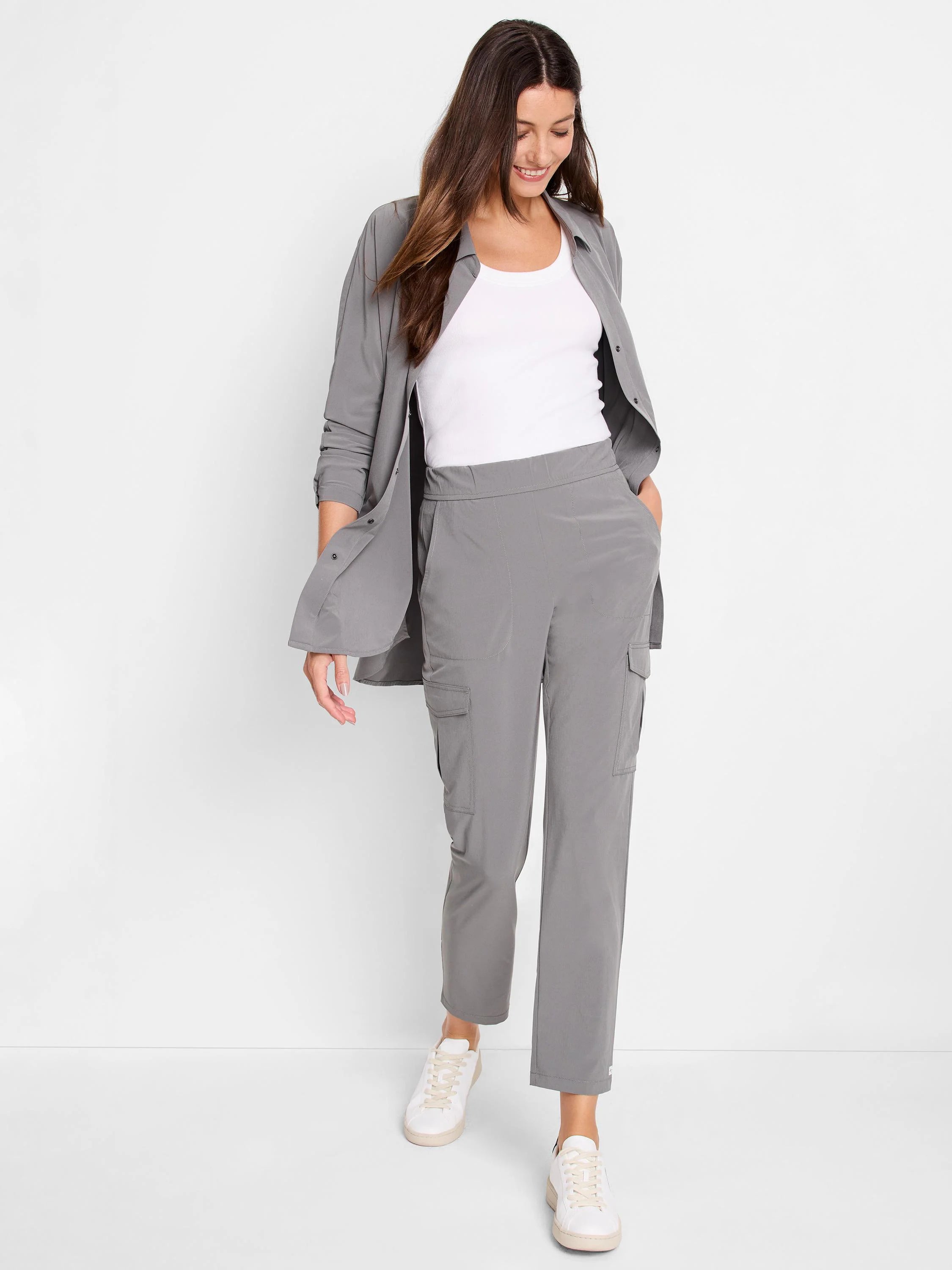 Gray long-sleeve Tech Stretch shirt with collar and button-down front. Shown unbuttoned over a white tank top.