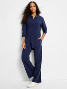 Navy blue, long-sleeve, collared shirt with a relaxed fit, worn with matching wide-leg pants.
