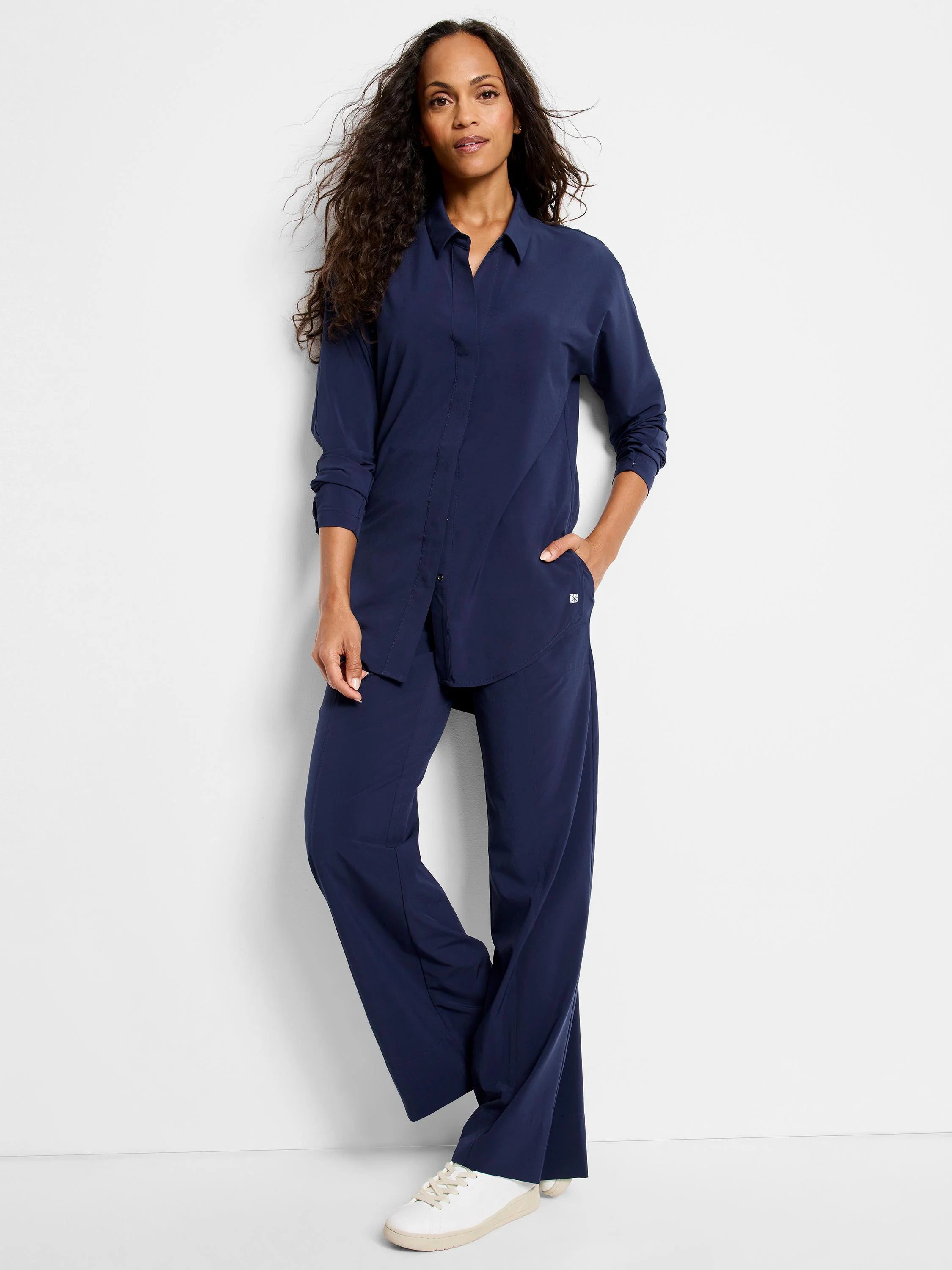 Navy blue, long-sleeve, collared shirt with a relaxed fit, worn with matching wide-leg pants.