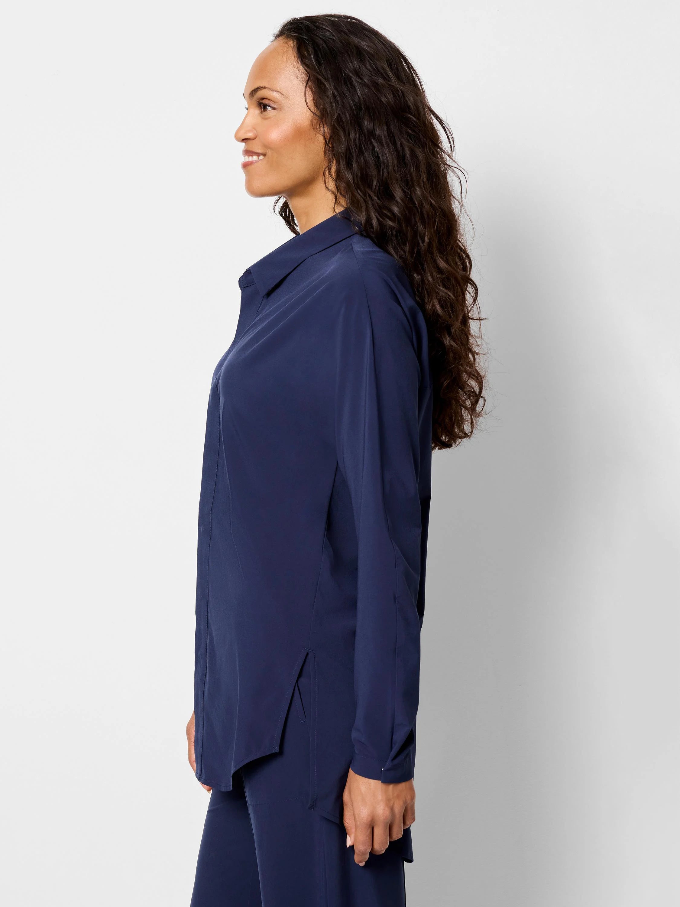 Navy blue collared shirt with long sleeves and side slits, worn by a woman in a relaxed fit.