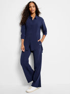 Navy Tech Stretch Shirt: collared, button-front, long sleeves, relaxed tunic length with side slits.